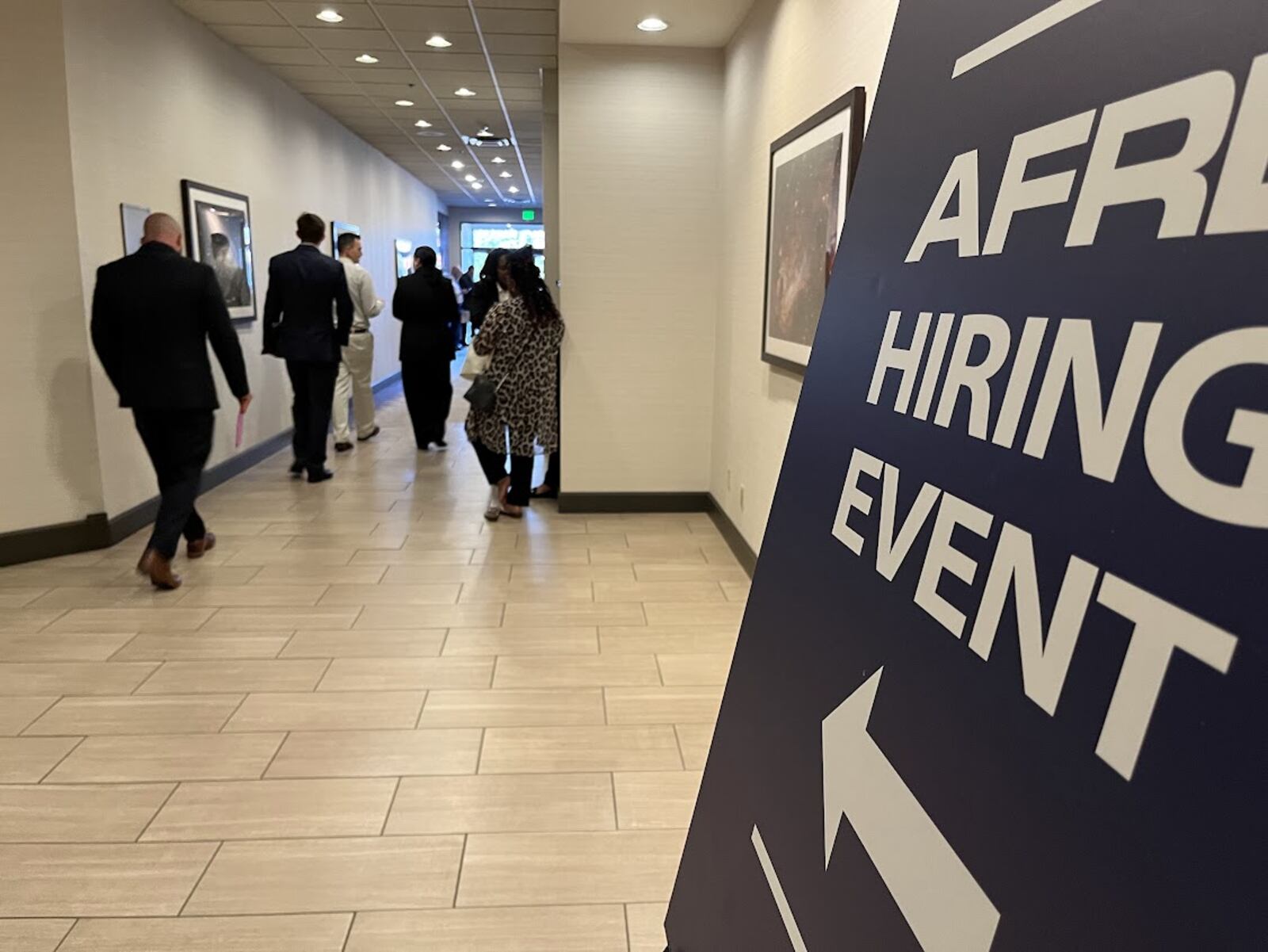 Applicants walk to the Air Force Research Laboratory hiring event Tuesday at the Fairborn Holiday Inn. THOMAS GNAU/STAFF