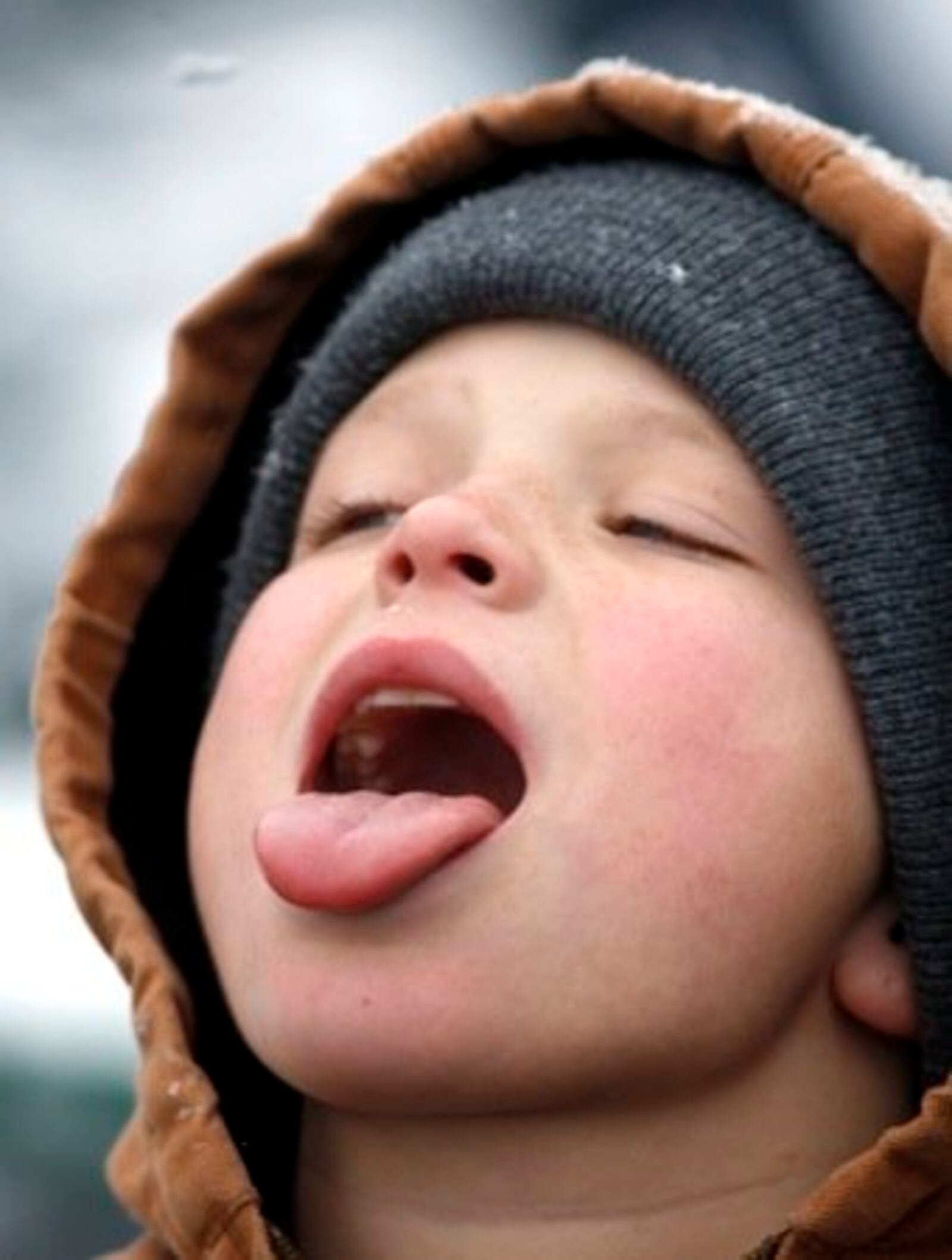 Steve Lopez, soon to be 13, of Englewood tries to catch snowflakes on his tongue Saturday, Dec. 4, while at the RiverScape MetroPark ice skating rink for a birthday celebration with his grandmother.