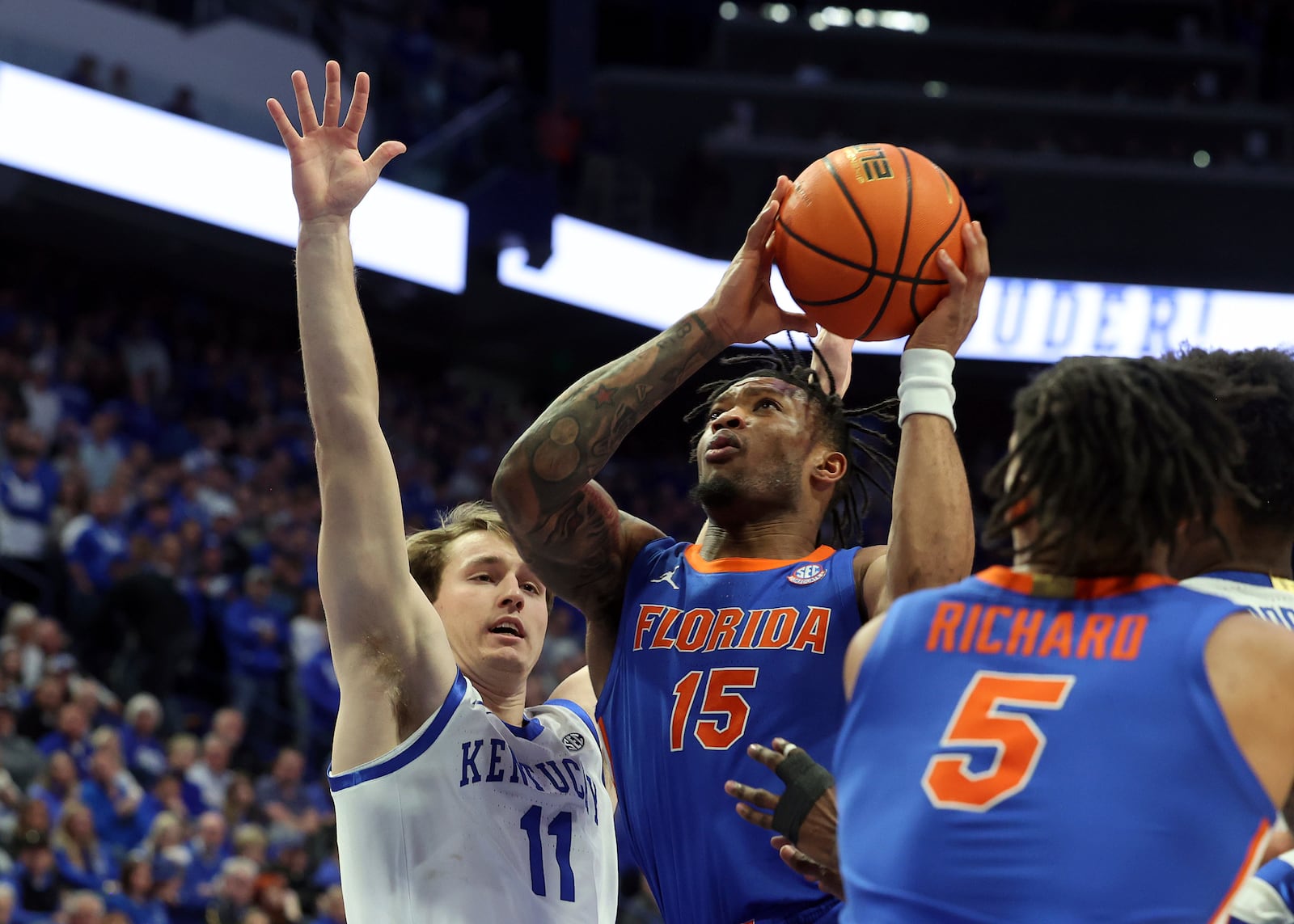 Florida's Alijah Martin (15) shoots past Kentucky's Travis Perry (11) during the second half of an NCAA college basketball game in Lexington, Ky., Saturday, Jan. 4, 2025. (AP Photo/James Crisp)