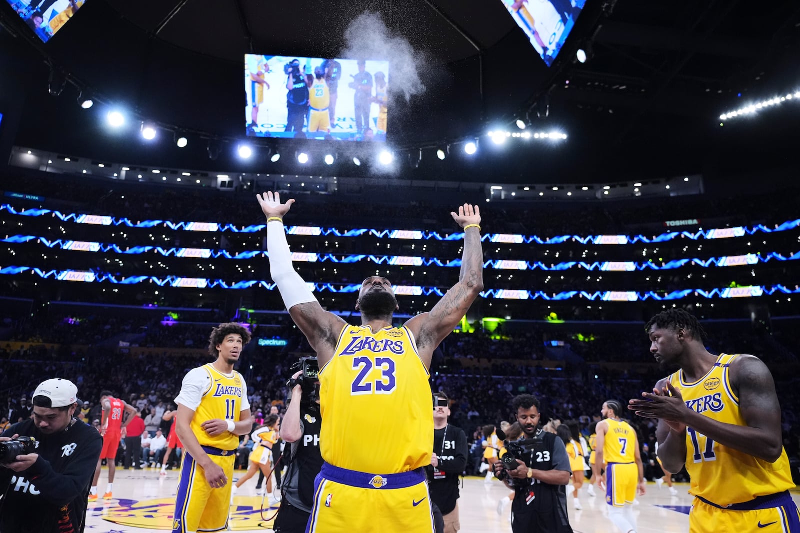 Los Angeles Lakers forward LeBron James throws chalk in the air before an NBA basketball game against the New Orleans Pelicans, Tuesday, March 4, 2025, in Los Angeles. (AP Photo/Jae C. Hong)