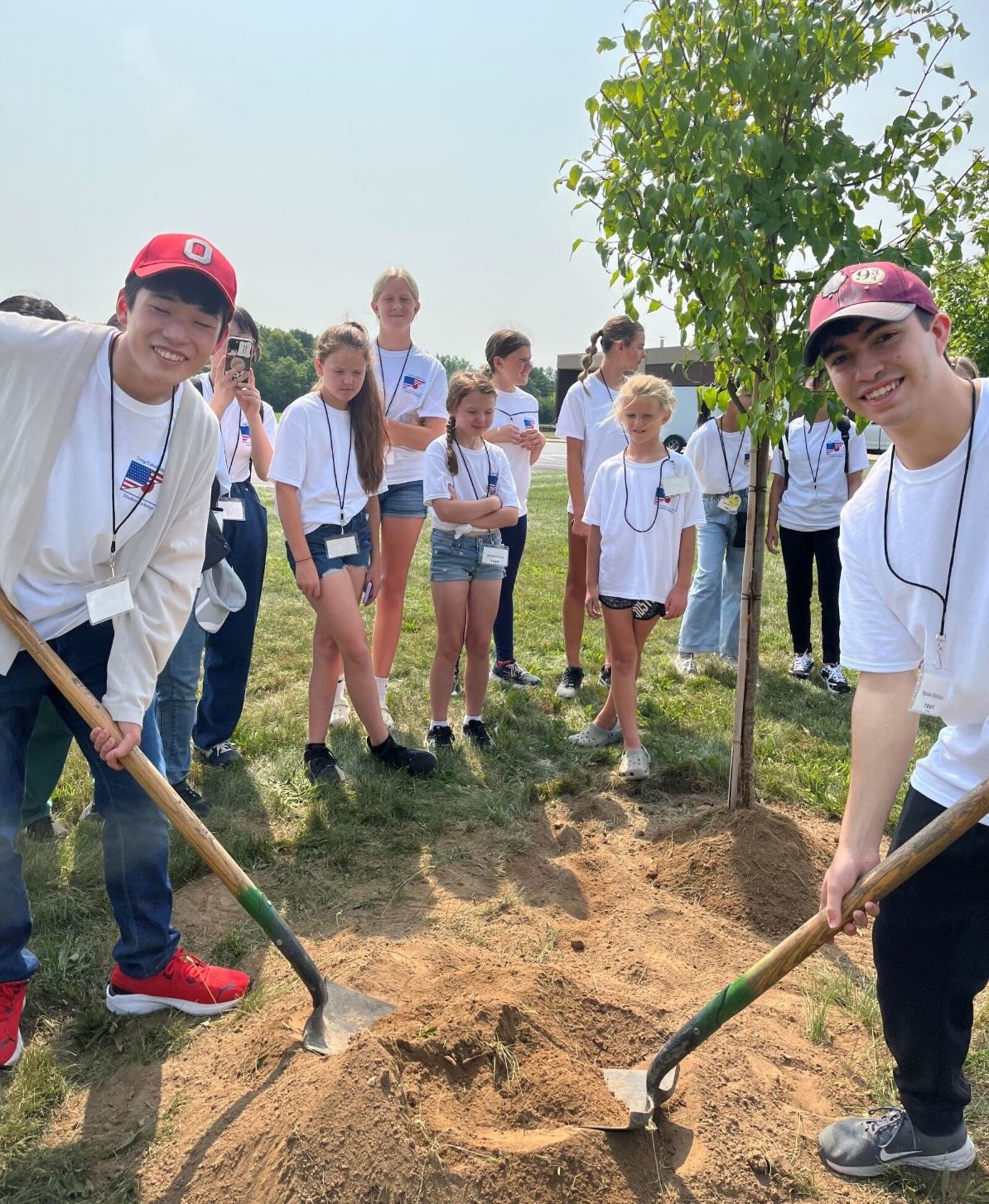 Students from Troy City Schools and Takahashi City, Japan, plant a memory tree at Troy Junior High School earlier this month. Contributed photo 