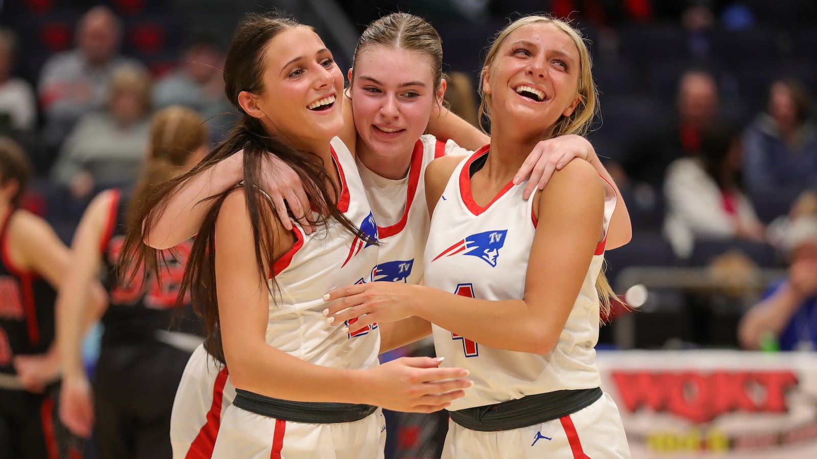 Tri-Village High School seniors Torie Richard (left), Morgan Hunt and Rylee Sagester celebrate as they walk off the floor late in the fourth quarter of their 51-34 victory over Berlin Hiland in a Division IV state semifinal on Thursday night at University of Dayton Arena. CONTRIBUTED PHOTO BY MICHAEL COOPER