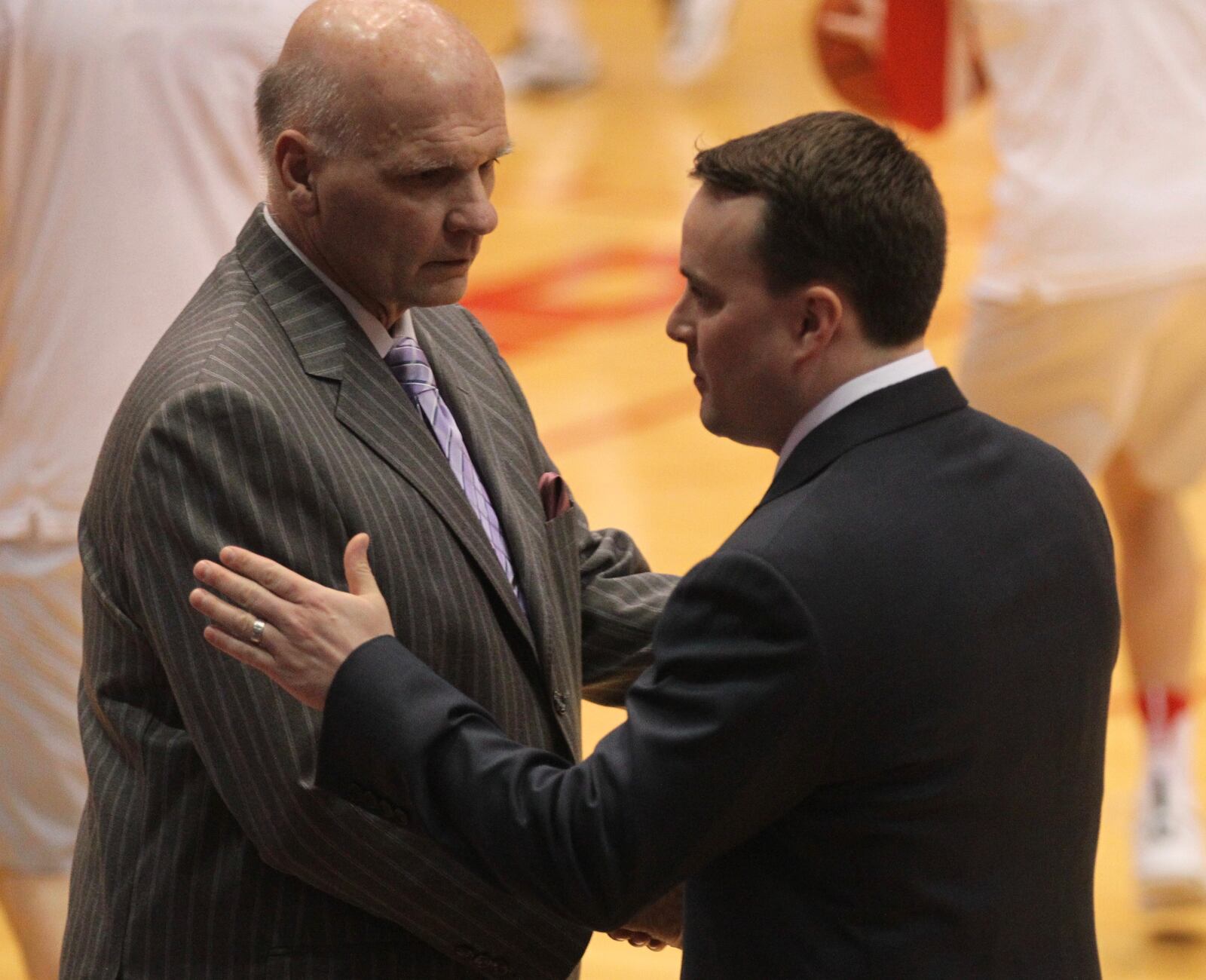 St. Joseph’s coach Phil Martelli and Dayton coach Archie Miller shake hands before a game on Feb. 7, 2017, at UD Arena. David Jablonski/Staff