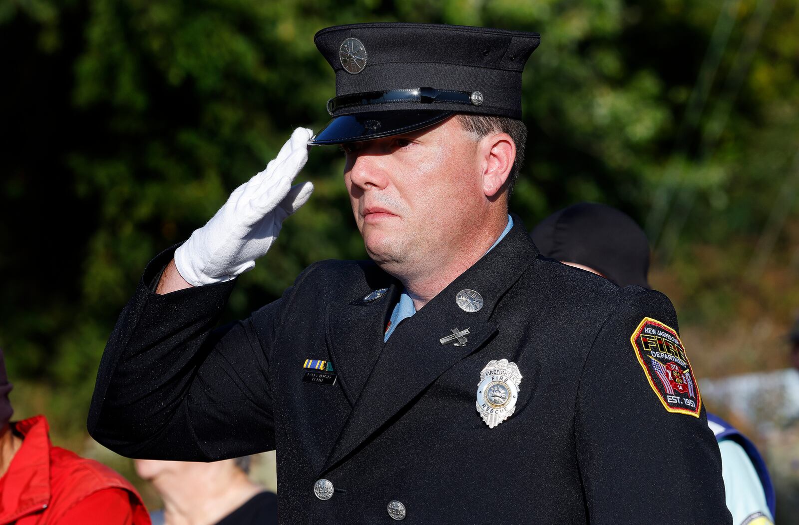 New Jasper Twp. Firefighter Larry Trusty paid his respects to the victims of 9/11 Wednesday, Sept. 11, 2024 at the Beavercreek 9/11 Memorial Ceremony. MARSHALL GORBY\STAFF