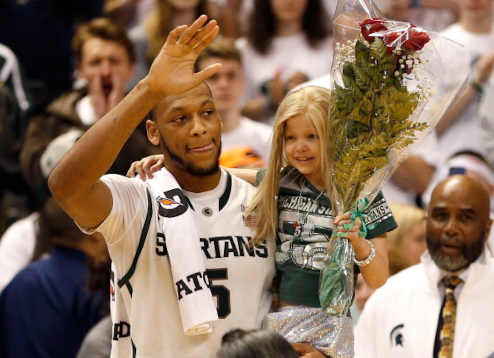 EAST LANSING, MI - FEBRUARY 06: Adreian Payne #5 of the Michigan State Spartans walks on the floor for Senior night with Lacey Holsworth, a 8-year-old from St. Johns Michigan who is battling cancer, after defeating the Iowa Hawkeyes 86-76 at the Jack T. Breslin Student Events Center on February 6, 2014 in East Lansing, Michigan. (Photo by Gregory Shamus/Getty Images)