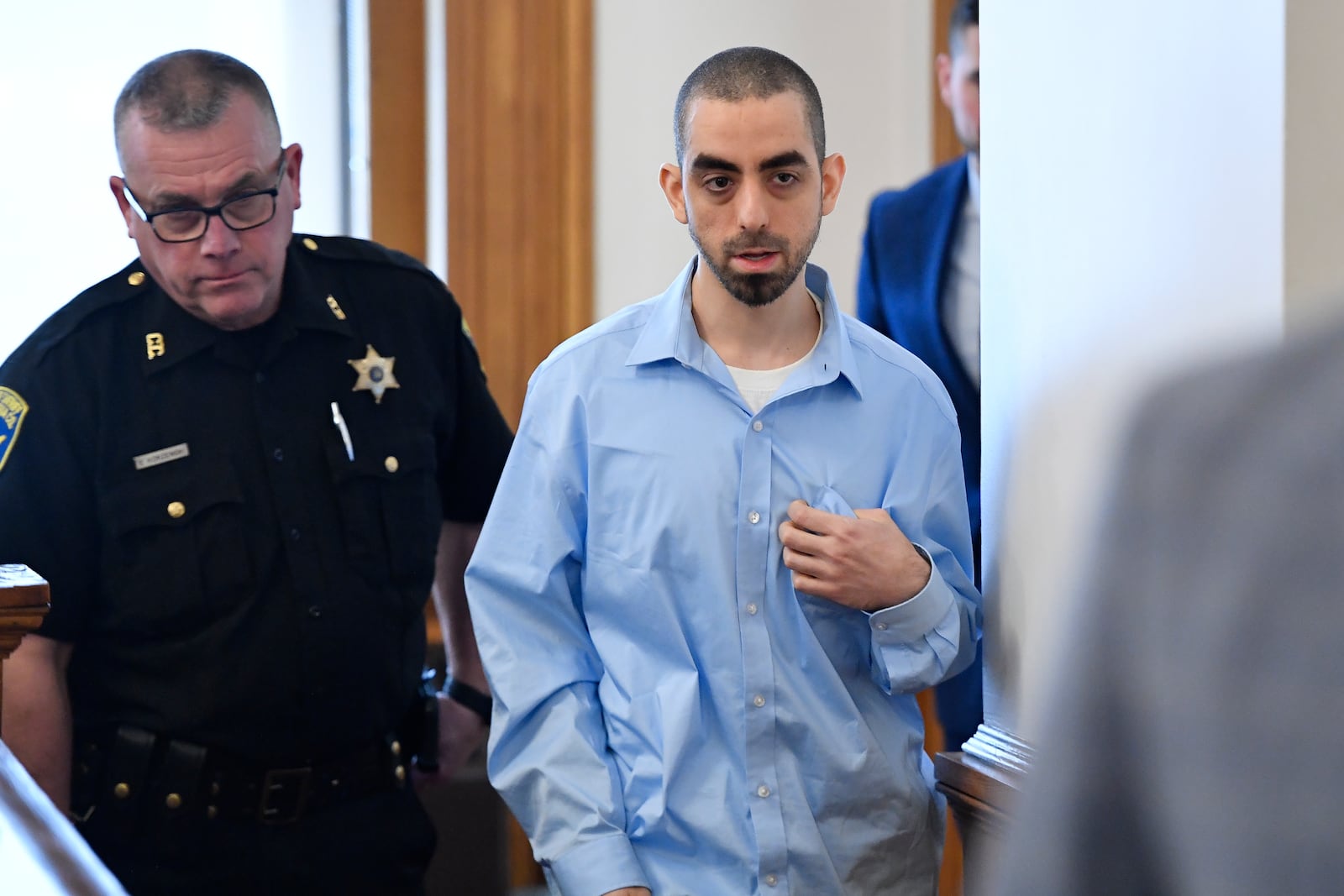 Hadi Matar, right, charged with severely injuring author Salman Rushdie in a 2022 knife attack, is led in to Chautauqua County court in Mayville, N.Y., Monday, Feb. 10, 2025. (AP Photo/Adrian Kraus)