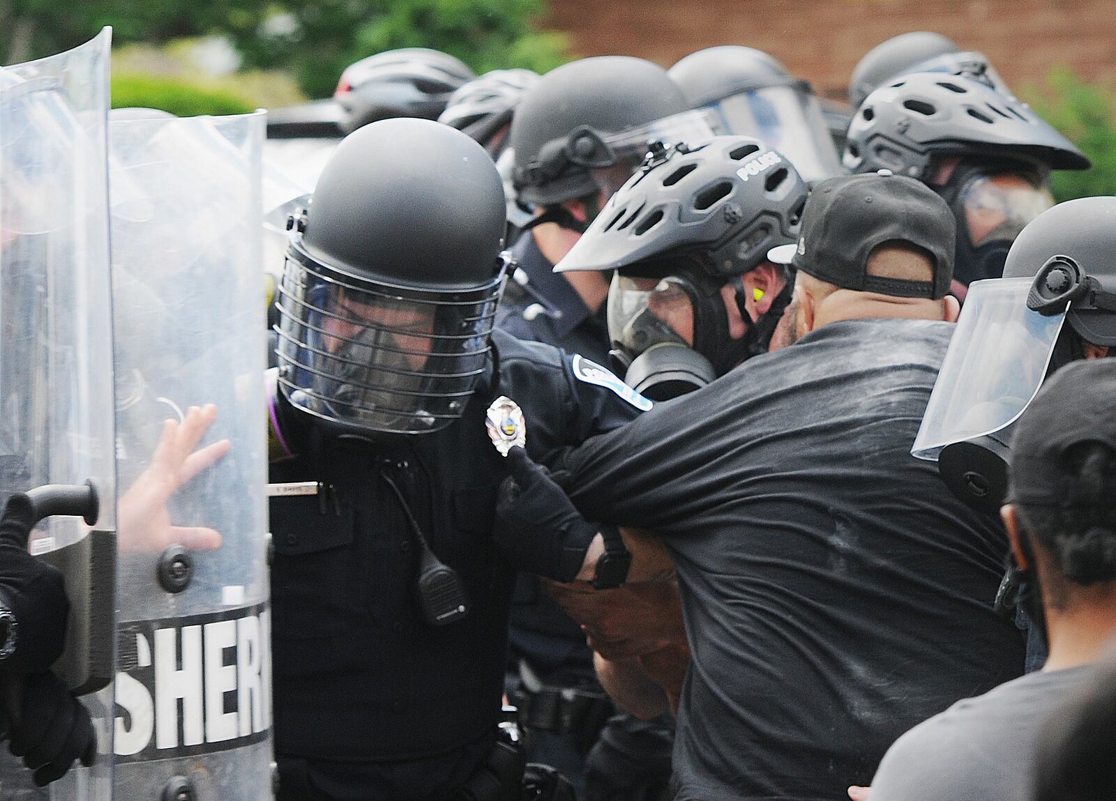 Police take down a protester on Wayne Ave. Saturday. MARSHALL GORBY\STAFF