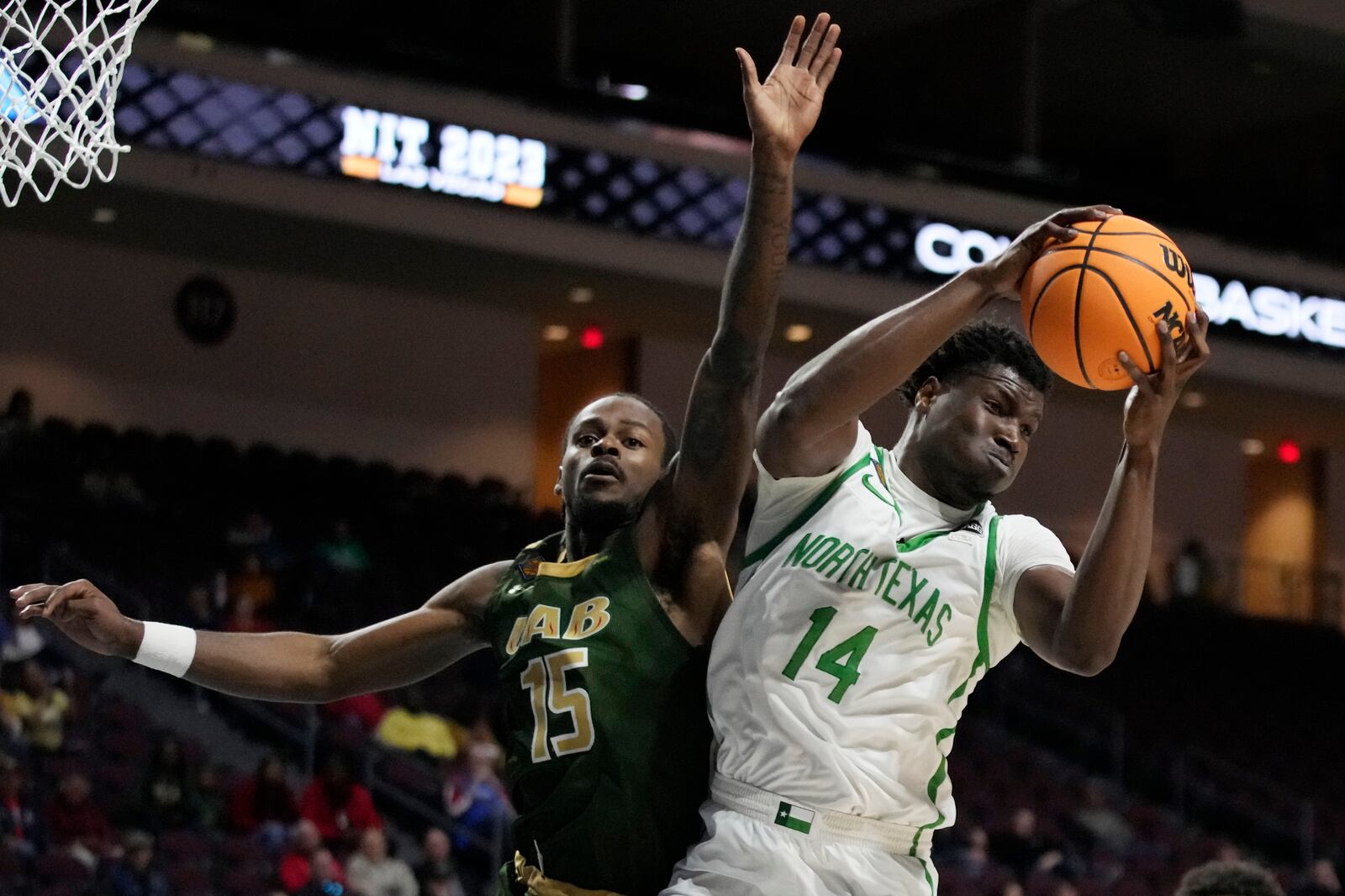 North Texas' Moulaye Sissoko (14) grabs a rebound against UAB's Trey Jemison (55) during the second half of an NCAA college basketball game in the final of the NIT, Thursday, March 30, 2023, in Las Vegas. (AP Photo/John Locher)