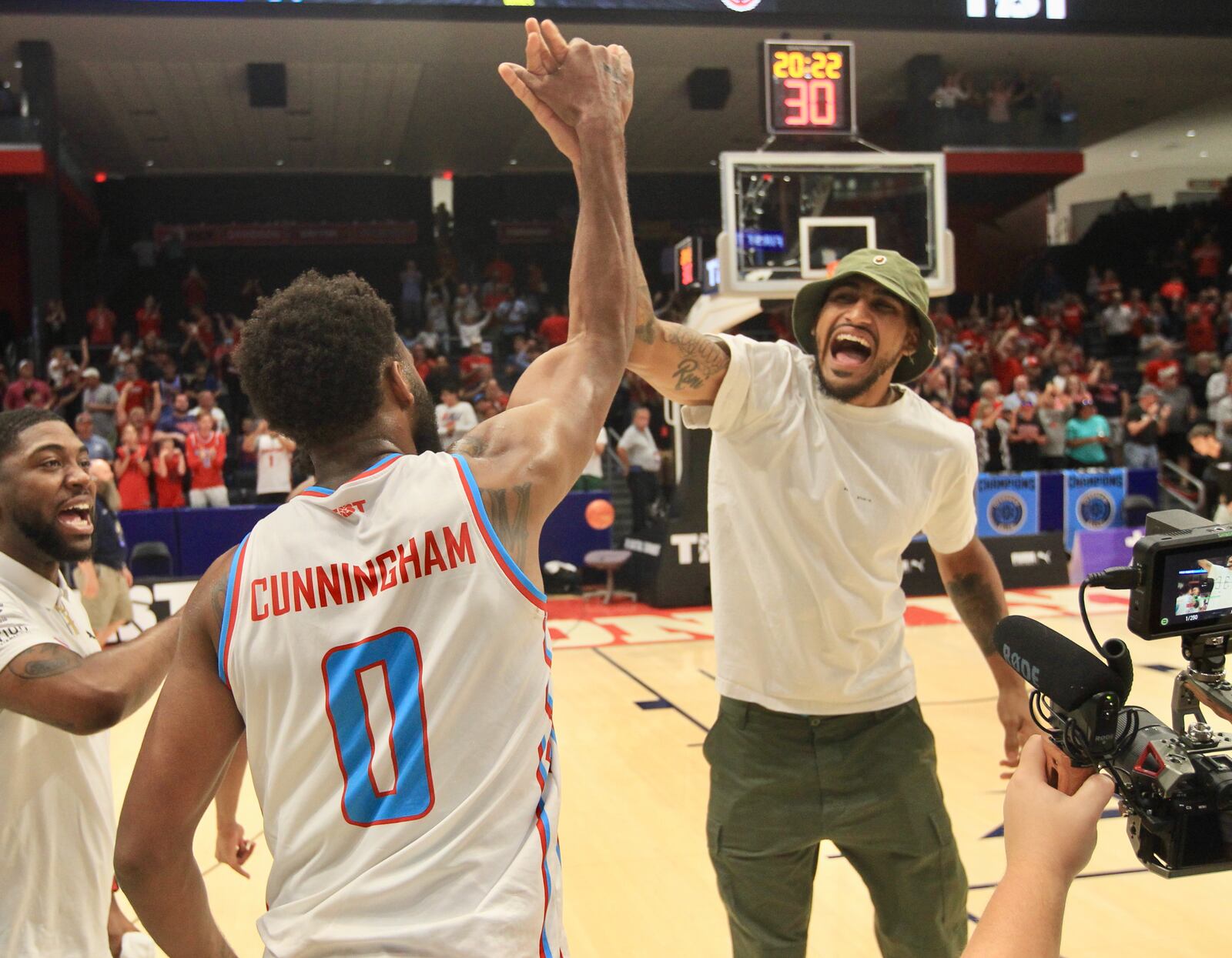 Obi Toppin, right, and Josh Cunningham celebrate the Red Scare's victory against The Money Team on Wednesday, July 27, in the third round of The Basketball Tournament at UD Arena in Dayton. David Jablonski/Staff