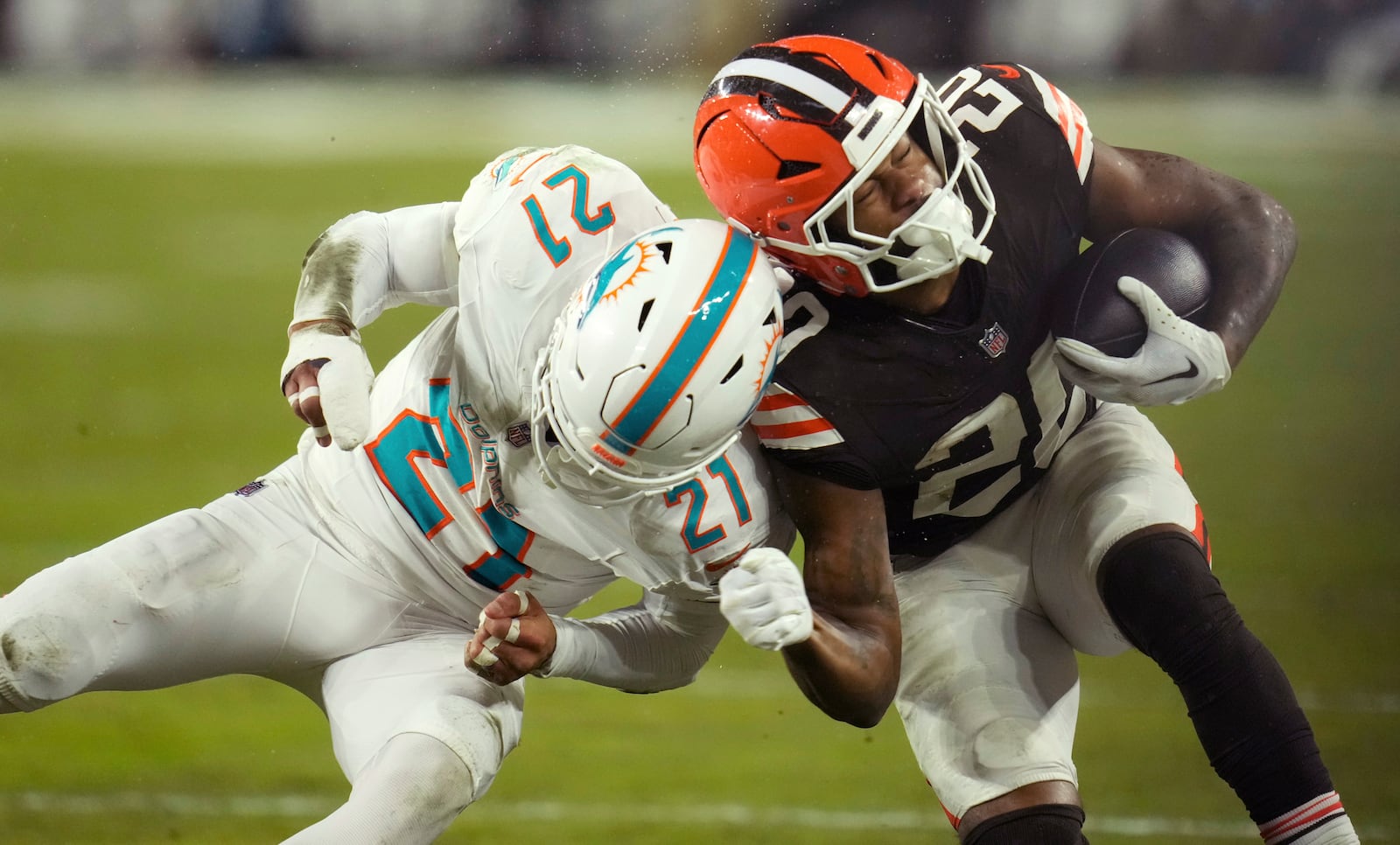 Cleveland Browns running back Pierre Strong Jr. (20) is tackled by Miami Dolphins safety Jordan Poyer (21) during the second half of an NFL football game Sunday, Dec. 29, 2024, in Cleveland. (AP Photo/Sue Ogrocki)