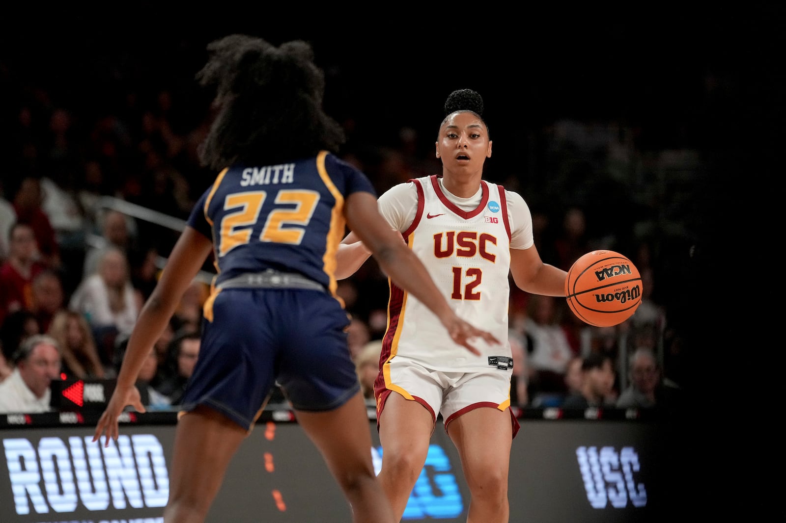 Southern California guard JuJu Watkins (12) dribbles against UNC Greensboro guard Nya Smith (22) during the first half in the first round of the NCAA college basketball tournament Saturday, March 22, 2025, in Los Angeles. (AP Photo/Eric Thayer)