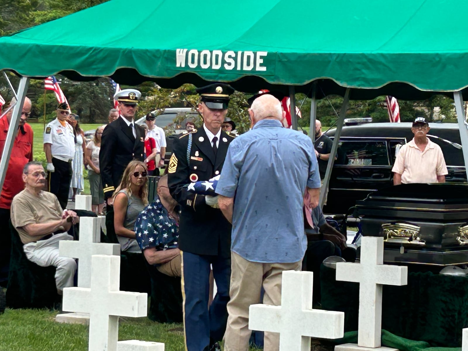 Dan Corson, the nephew of Lt. Dan Corson, is presented a folded American flag during his uncle's funeral Wednesday at Woodside Cemetery. RICK McCRABB/CONTRIBUTOR