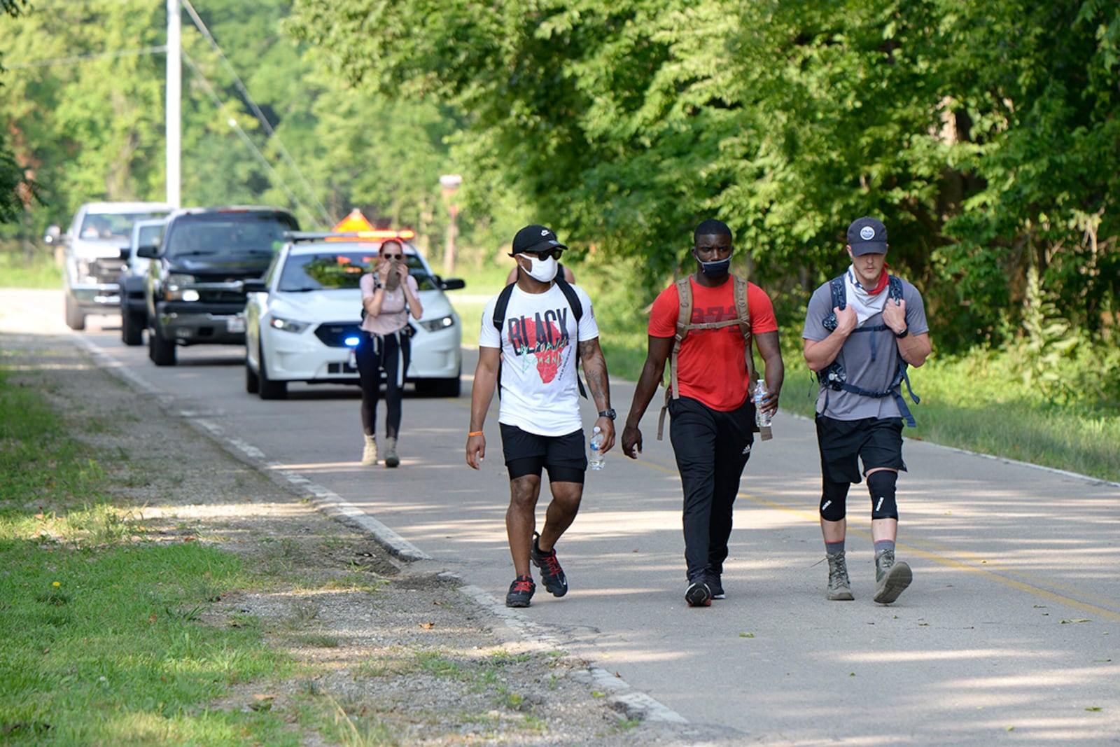 88th Force Support Squadron members Staff Sgt. Jamille Hicks (left), Staff Sgt. Melchizedek Martin (center) and Air Force Institute of Technology student 1st.Lt. Mike Hughes participate in the Airman’s Fight Against Social Injustice and For Diversity Inclusion 5K Ruck March at Wright-Patterson Air Force Base, July 10. U.S. AIR FORCE PHOTO/TY GREENLEES