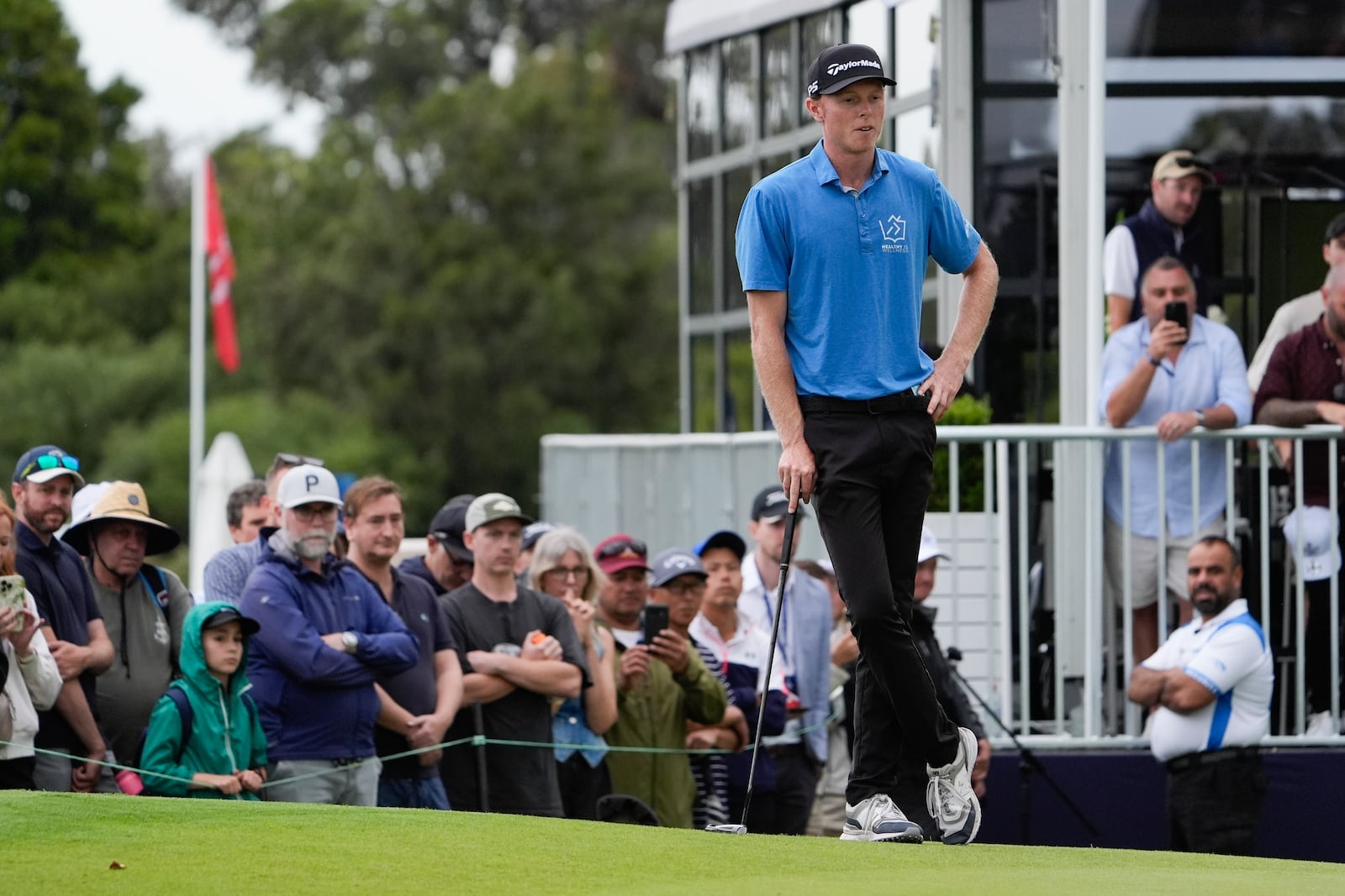 Ryggs Johnston of the United States waits to putt on the 18th green during the final round of the Australian Open golf championship at the Kingston Heath Golf Club in Melbourne, Australia, Sunday, Dec. 1, 2024. (AP Photo/Asanka Brendon Ratnayake)