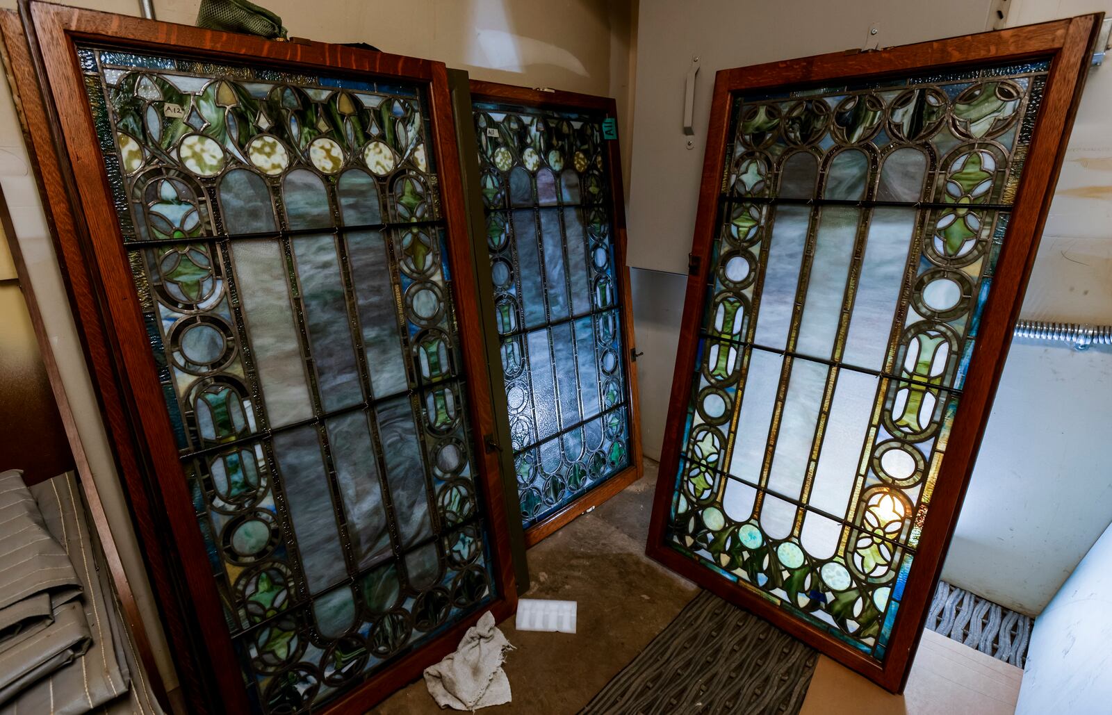 BeauVerre Riordan Stained Glass Studios in Middletown is in the process of restoring multiple Tiffany glass windows from the chapel of Woodland Historic Cemetery and Arboretum in Dayton. These are some of the smaller side windows that have been restored. NICK GRAHAM / STAFF 

