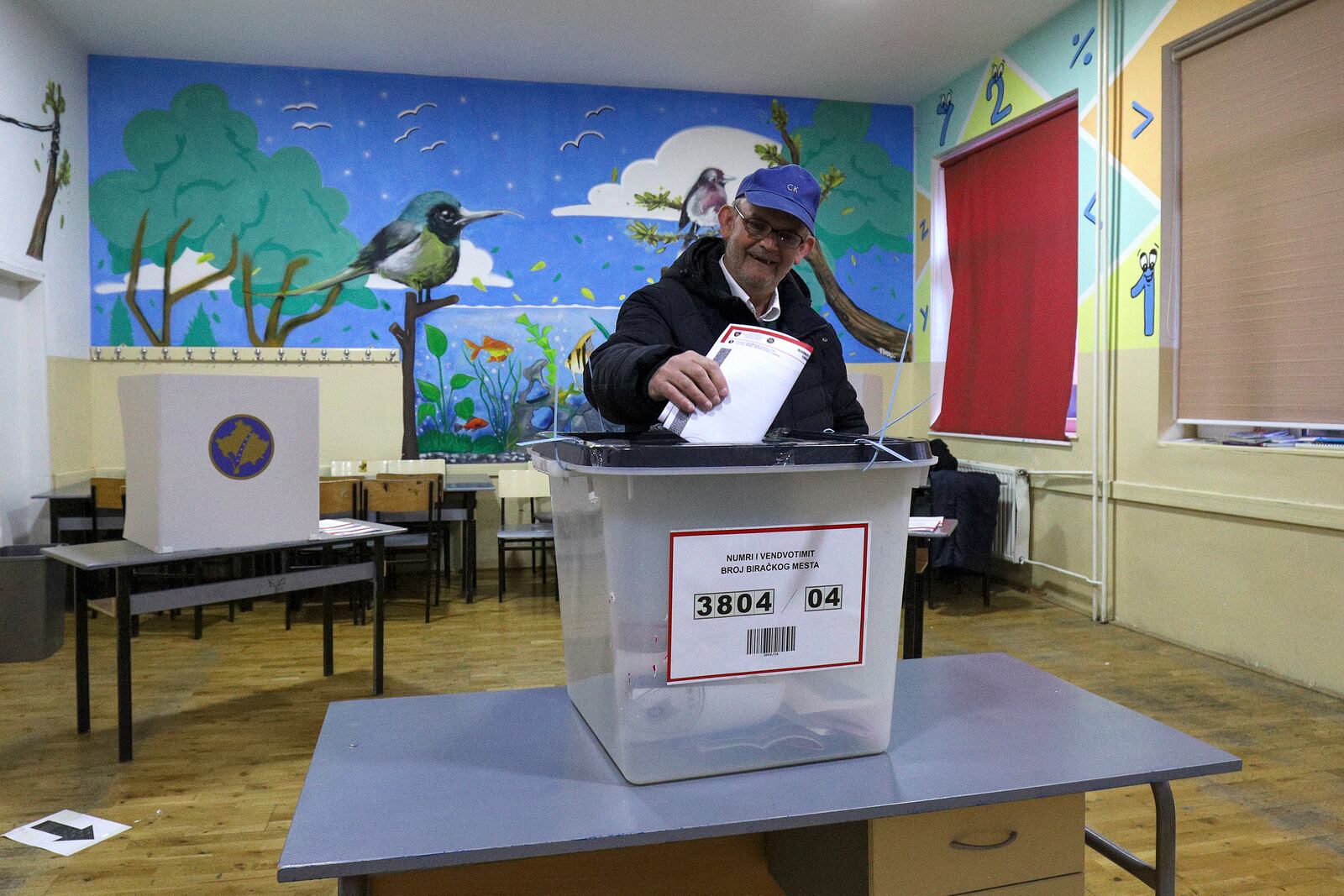 A man casts his ballot for a parliamentary election at a polling station in the northern Serb-dominated part of ethnically divided town of Mitrovica, Kosovo, Sunday, Feb. 9, 2025. (AP Photo/Bojan Slavkovic)