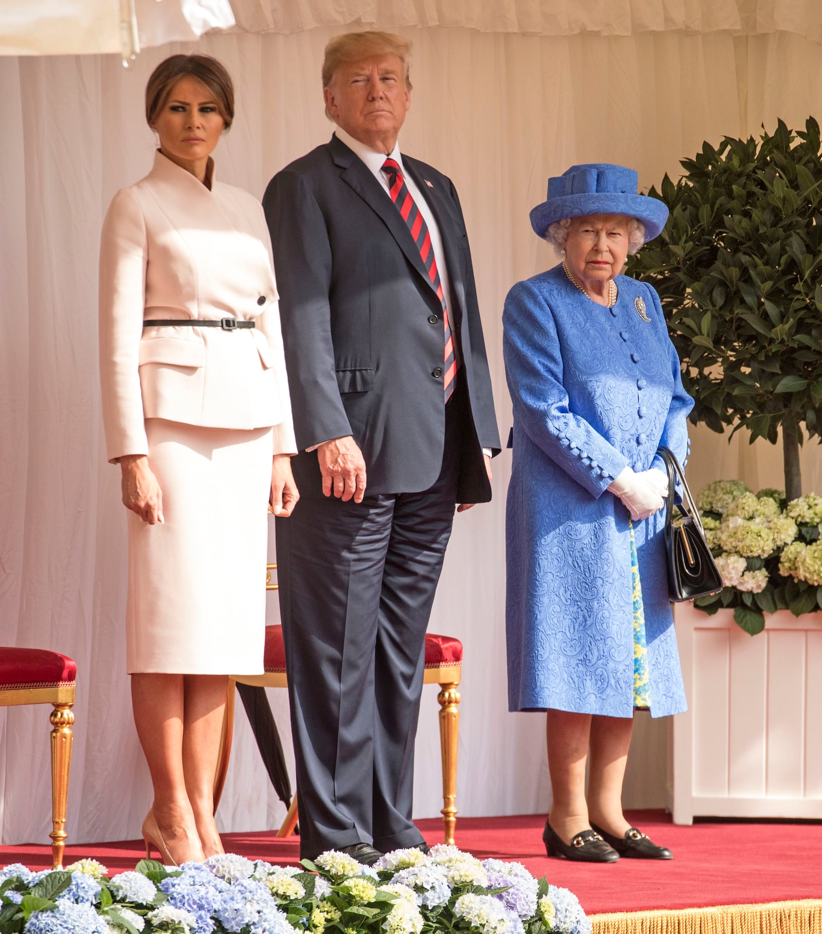 U.S. President Donald Trump and first lady Melania Trump stand with Britain's Queen Elizabeth II on the dais in the Quadrangle of Windsor Castle on July 13, 2018 in Windsor, England.