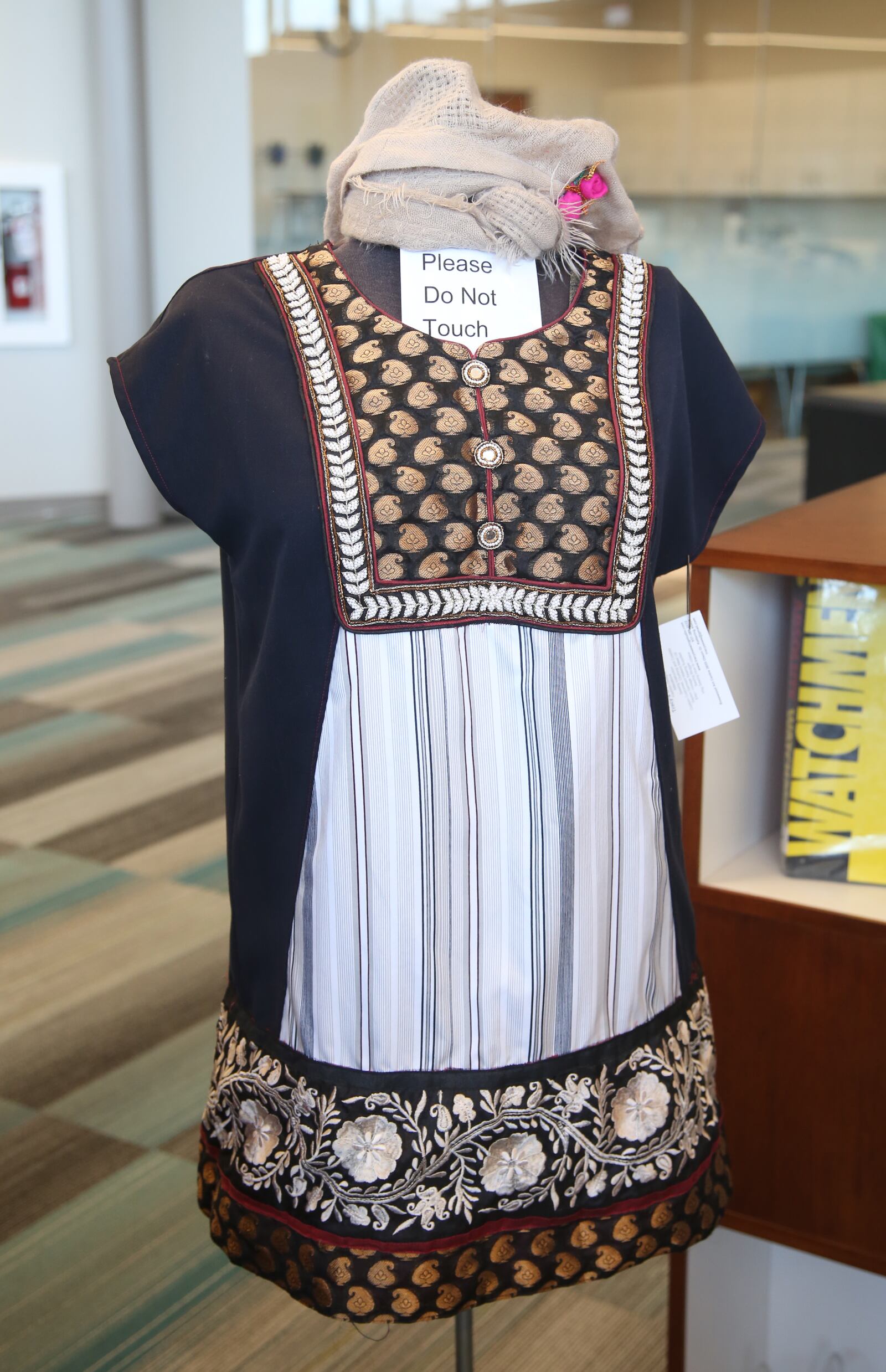 Tracy McElfresh, an artist and owner of Tracy’s Sewing Studio, has made two dresses from recycled clothing for The Climate Awareness Project, an art exhibition about environmental concerns on display at Woodbourne Library in Centerville. LISA POWELL / STAFF