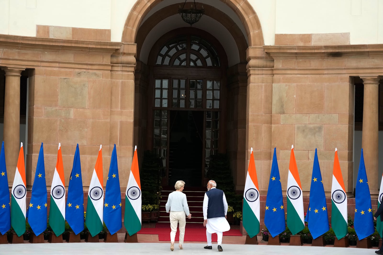 Indian Prime Minister Narendra Modi talks to European Commission President Ursula von der Leyen as they leave for their delegation level meeting in New Delhi, India, Friday, Feb. 28, 2025. (AP Photo/Manish Swarup)