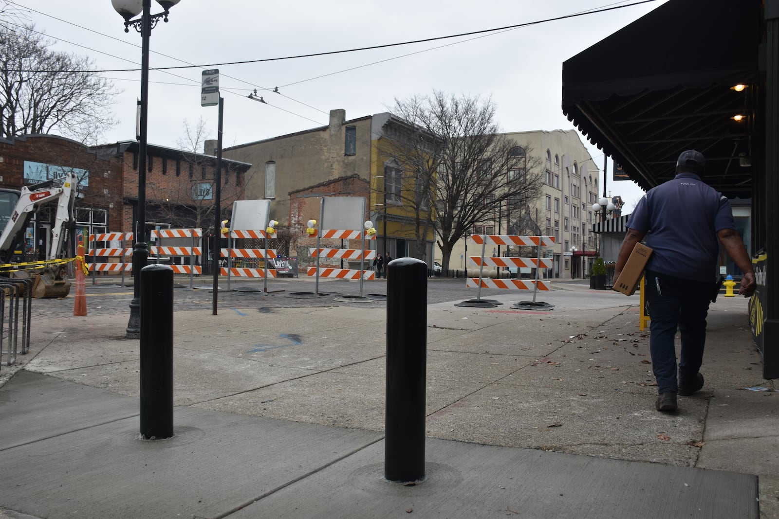 City of Dayton is installing bollards on East Fifth Street and side streets in the Oregon District, which will help shut the streets down to vehicular traffic during Out on 5th and similar kinds of events. CORNELIUS FROLIK / STAFF