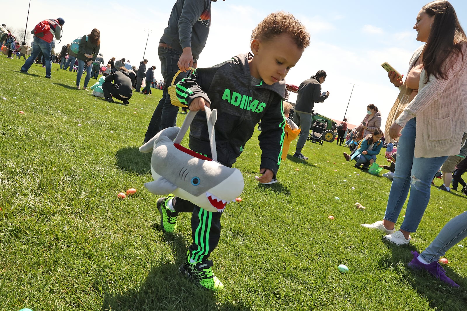 Hundreds of children raced across the driving range at Young's Jersey Dairy picking up dyed hard boiled eggs during the annual Easter Egg Hunt in 2022. This year's hunt is set for Sunday, April 9. BILL LACKEY/STAFF