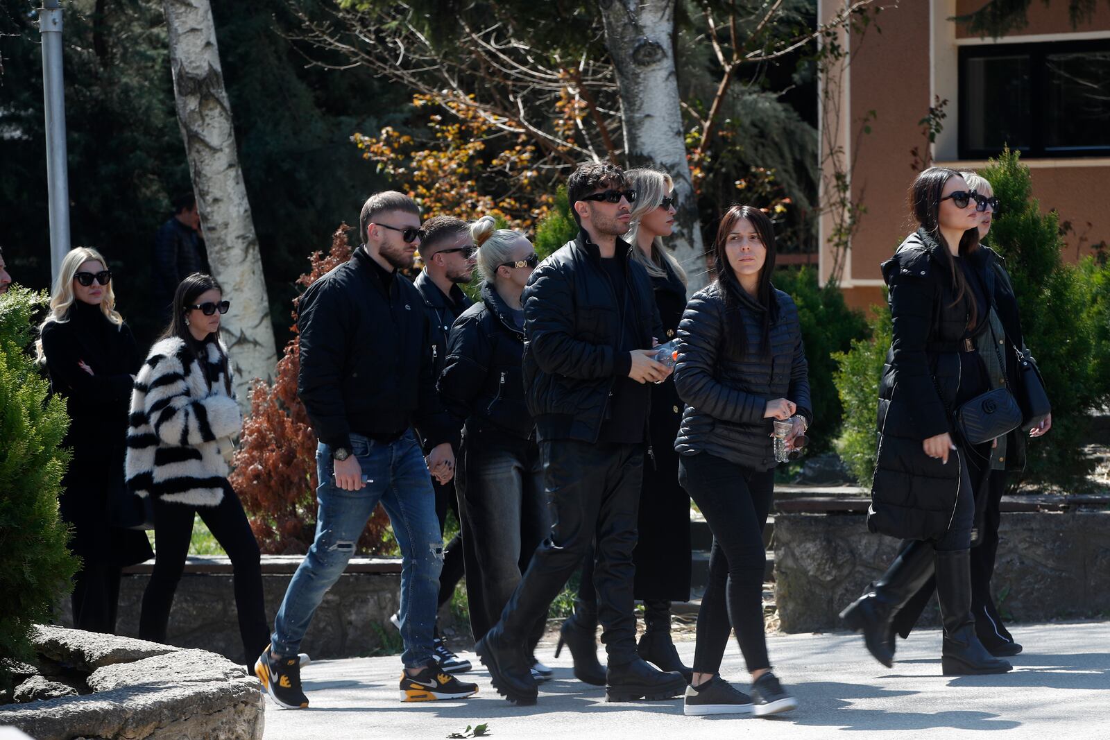 Relatives and friends walk in a procession during the funeral of Andrej Gjorgieski, one of the lead singers of Macedonian band DNK who was killed in a massive nightclub fire in the town of Kocani, at a cemetery in Skopje, North Macedonia, Thursday, March 20, 2025. (AP Photo/Boris Grdanoski)