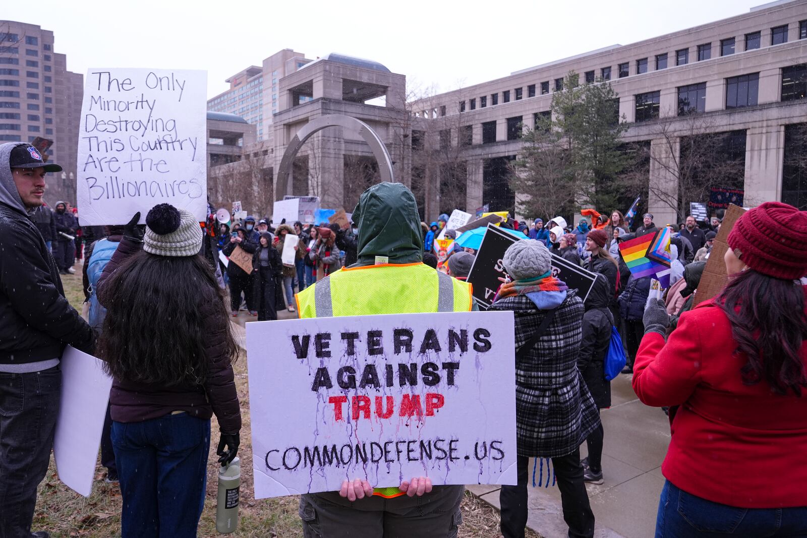 The ink on a protestors sign begins to run was rain fell on a protest against Project 20205 at the Statehouse in Indianapolis, Wednesday, Feb. 5, 2025. (AP Photo/Michael Conroy)