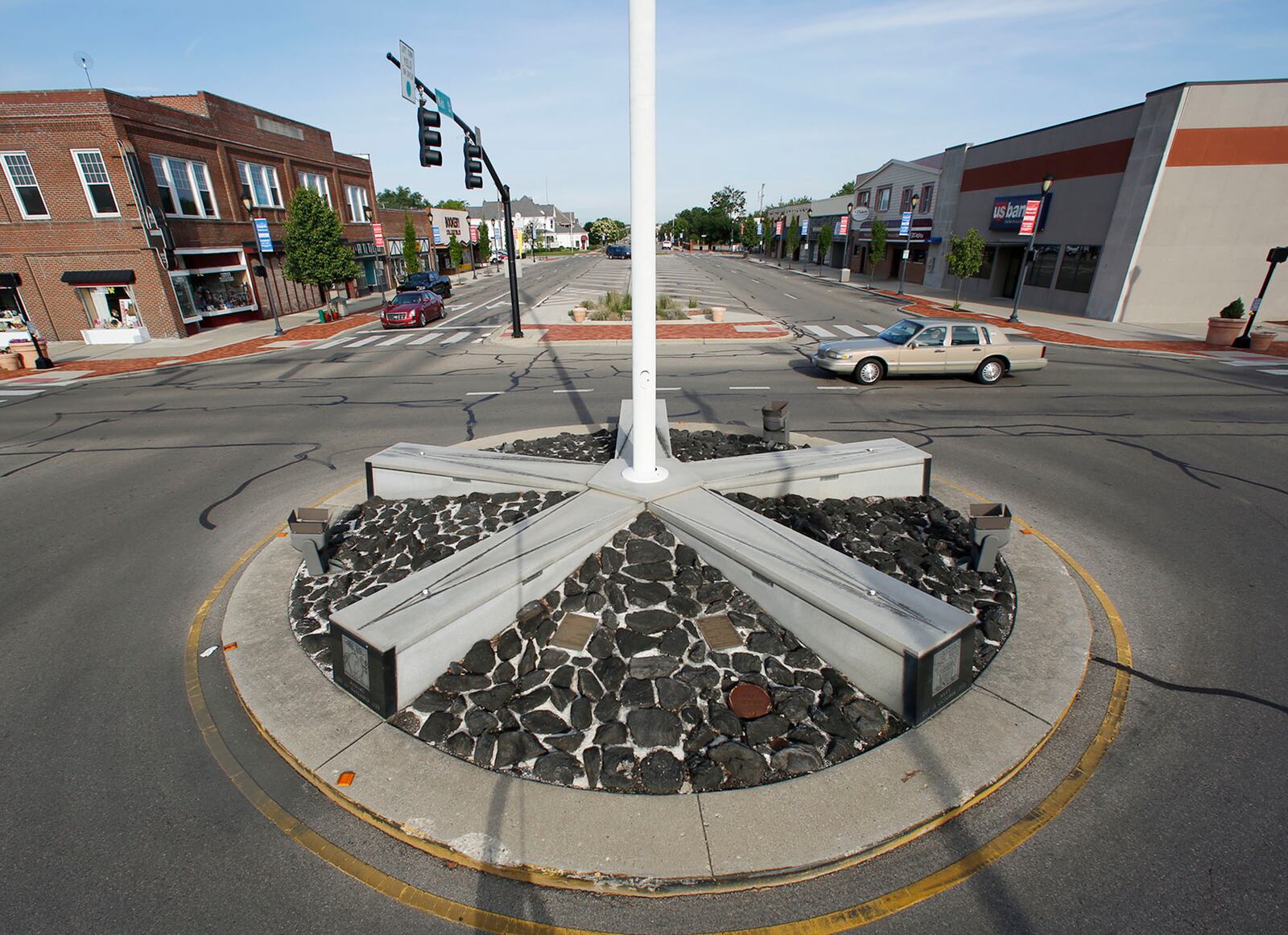 The Fairborn Veterans Memorial is located in the center of Central and Main Streets in downtown Fairborn with a prominent flag pole at its center.  The star shaped monument includes five obelisks for each of the armed service branches.   TY GREENLEES / STAFF