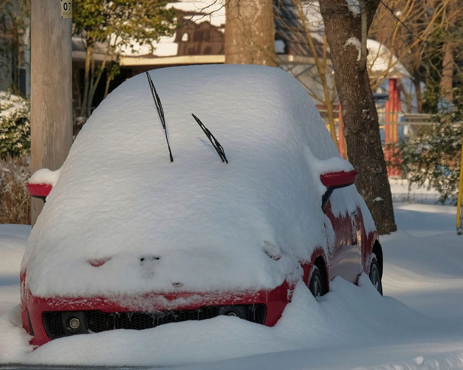 A small car parked in Elizabeth City, N.C. is seen nearly covered in snow, Thursday, Feb. 20, 2025. (Chris Day/The Daily Advance via AP)