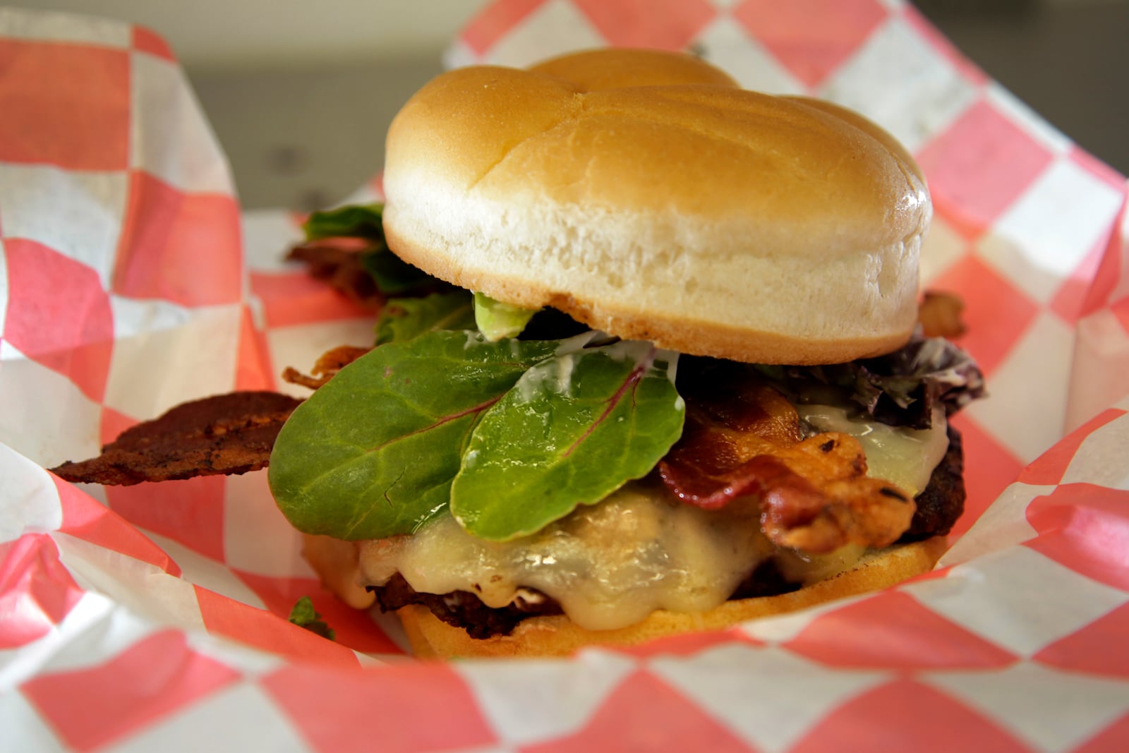 McNasty's Bacon Bacon Burger is topped with mayonaise, mixed greens, bacon, pepper jack cheese and bacon jam. LISA POWELL / STAFF