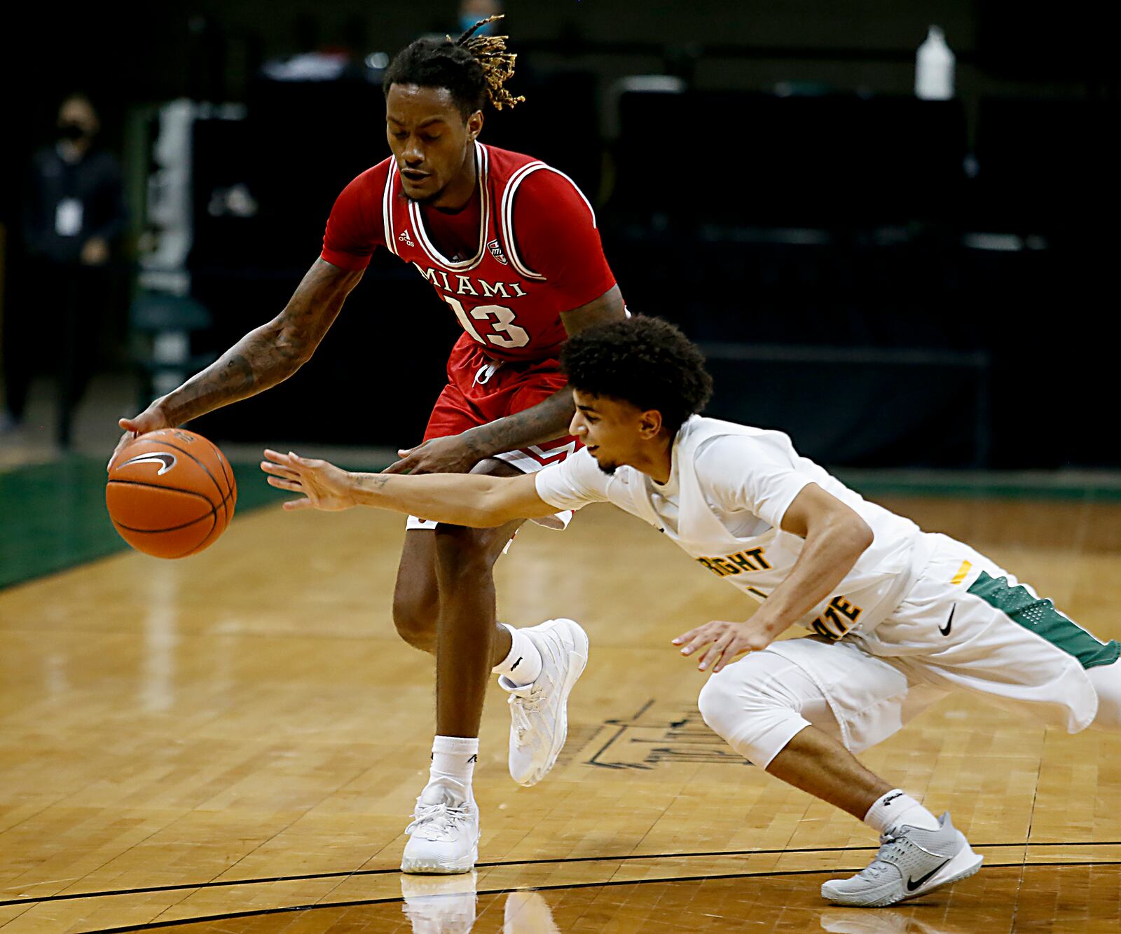 Wright State guard Trey Calvin knocks the ball away from Miami forward Dalonte Brown during a mens basketball game at the Nutter Center in Fairborn Saturday, Dec. 5, 2020. E.L. Hubbard/CONTRIBUTED