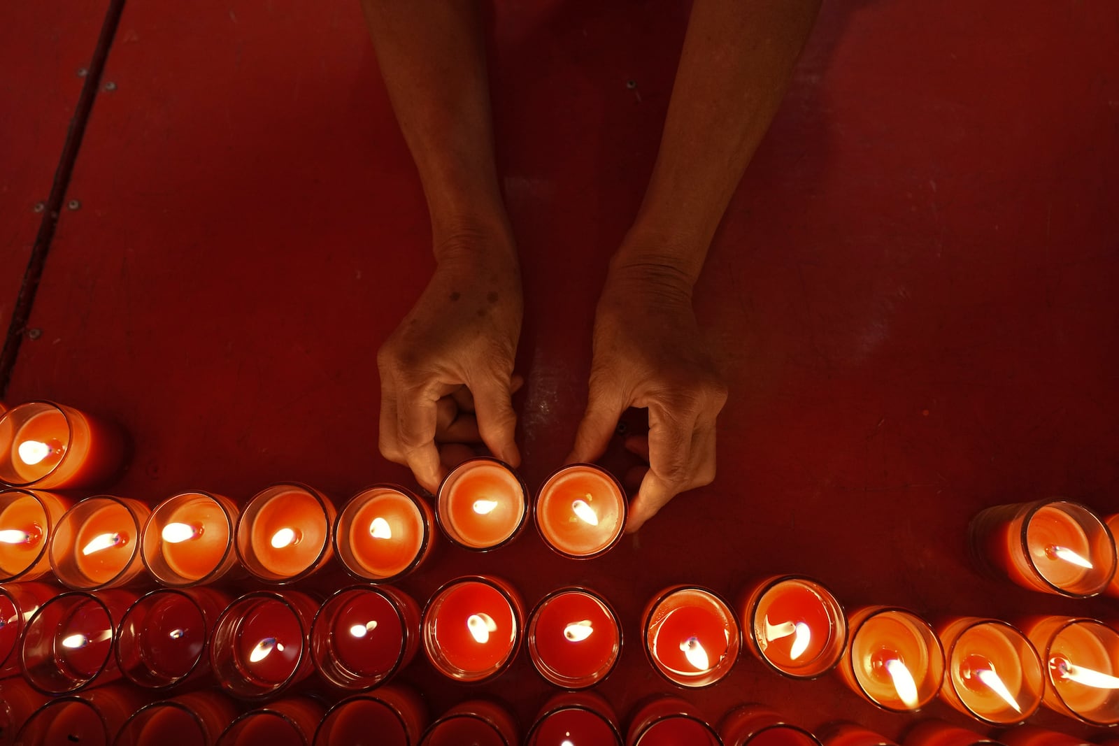 Ethnic Chinese Thai lay down candles after praying at the Leng Nuei Yee temple to celebrate the Lunar New Year in Bangkok, Thailand, Wednesday, Jan. 29, 2025. (AP Photo/Sakchai Lalit)