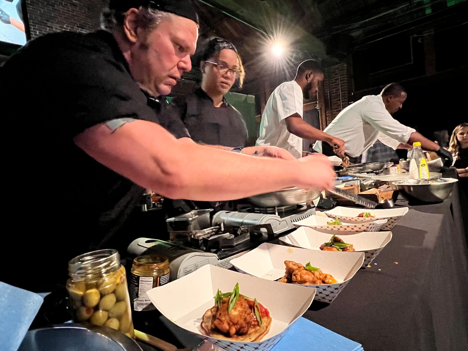 The final round of the Diced in Dayton Chef's Challenge saw the team from Corner Kitchen led by executive chef Gavin St. Denis (far left), face off agains the team from Rich Taste Catering led by chef and owner Gerald Richardson (far right). PHOTO BY ALEXIS LARSEN