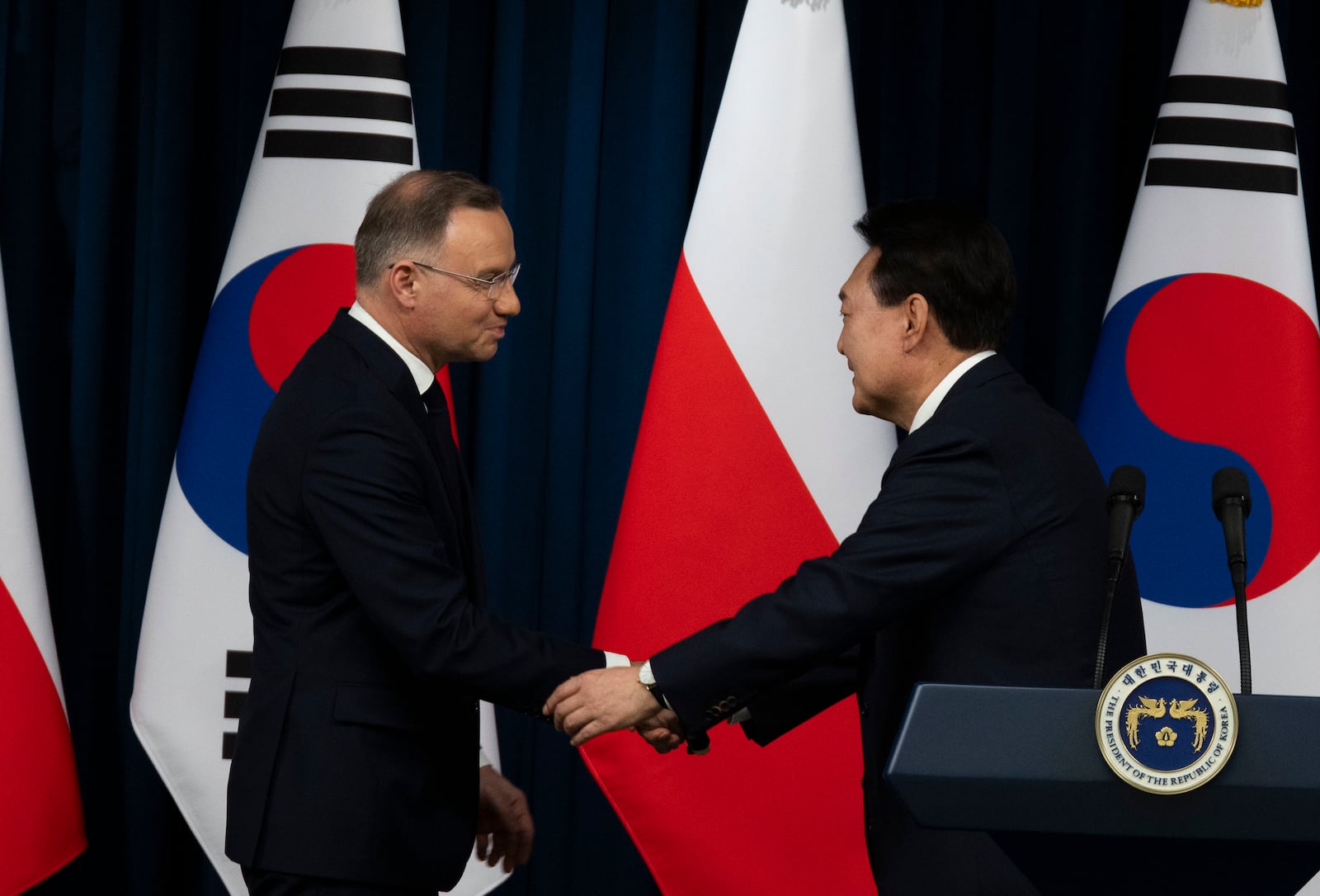 South Korean President Yoon Suk Yeol, right, and Poland's President Andrzej Duda, left, shake hands after a joint press conference at the Presidential Office in Seoul, South Korea, Thursday, Oct. 24, 2024. (Jeon Heon-Kyun/Pool Photo via AP)