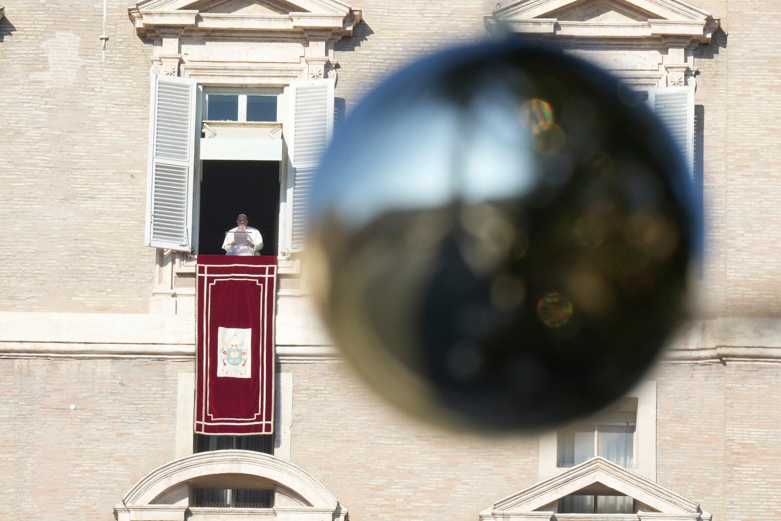 Pope Francis appears at his studio's window overlooking St. Peter's Square at The Vatican to bless pilgrims and faithful after presiding over a mass in St. Peter's Basilica on New Year's Day, Wednesday, Jan. 1, 2025. (AP Photo/Andrew Medichini)