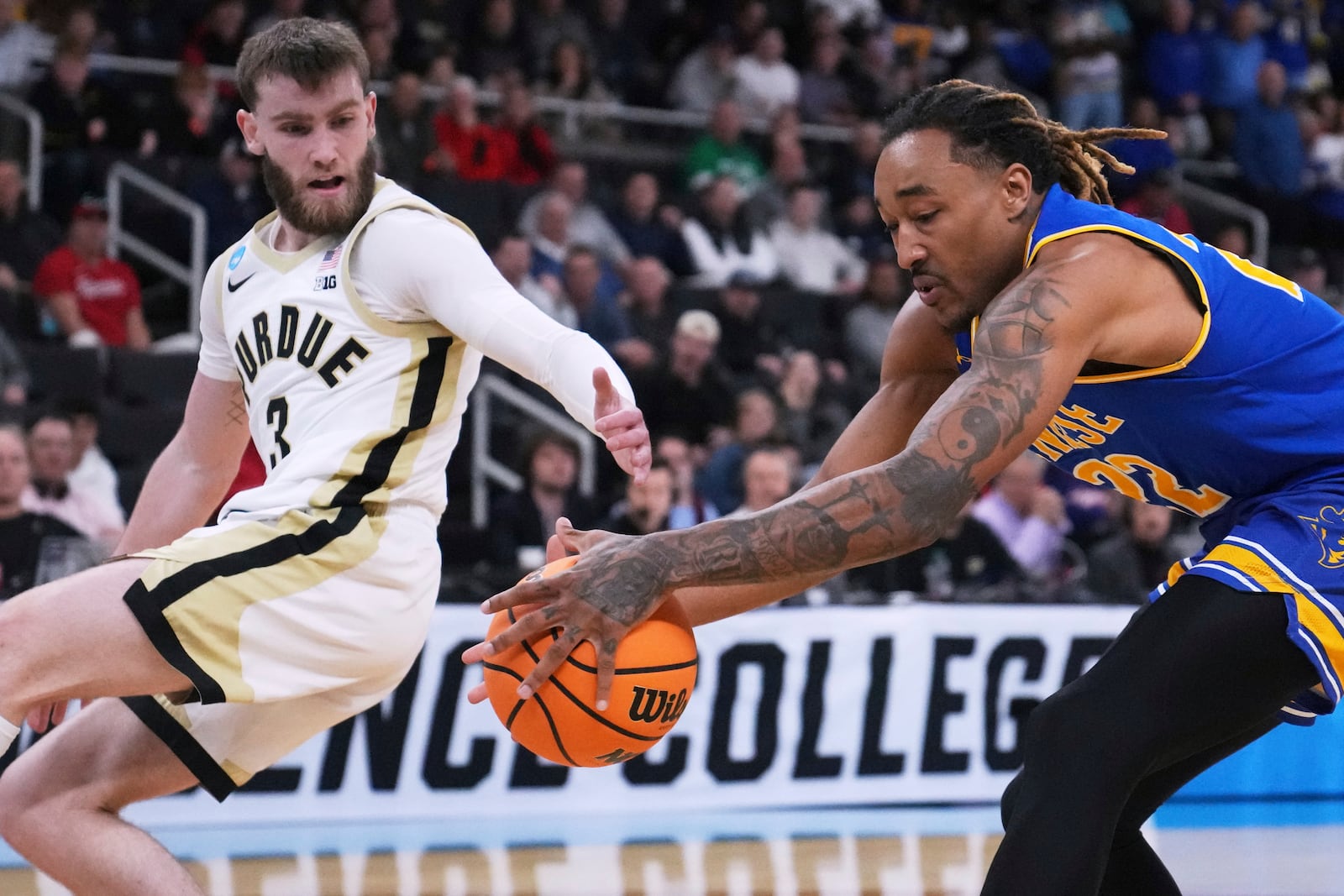 McNeese State forward Christian Shumate, right, grabs a loose ball against Purdue guard Braden Smith (3) during the first half in the second round of the NCAA college basketball tournament, Saturday, March 22, 2025, in Providence, R.I. (AP Photo/Charles Krupa)