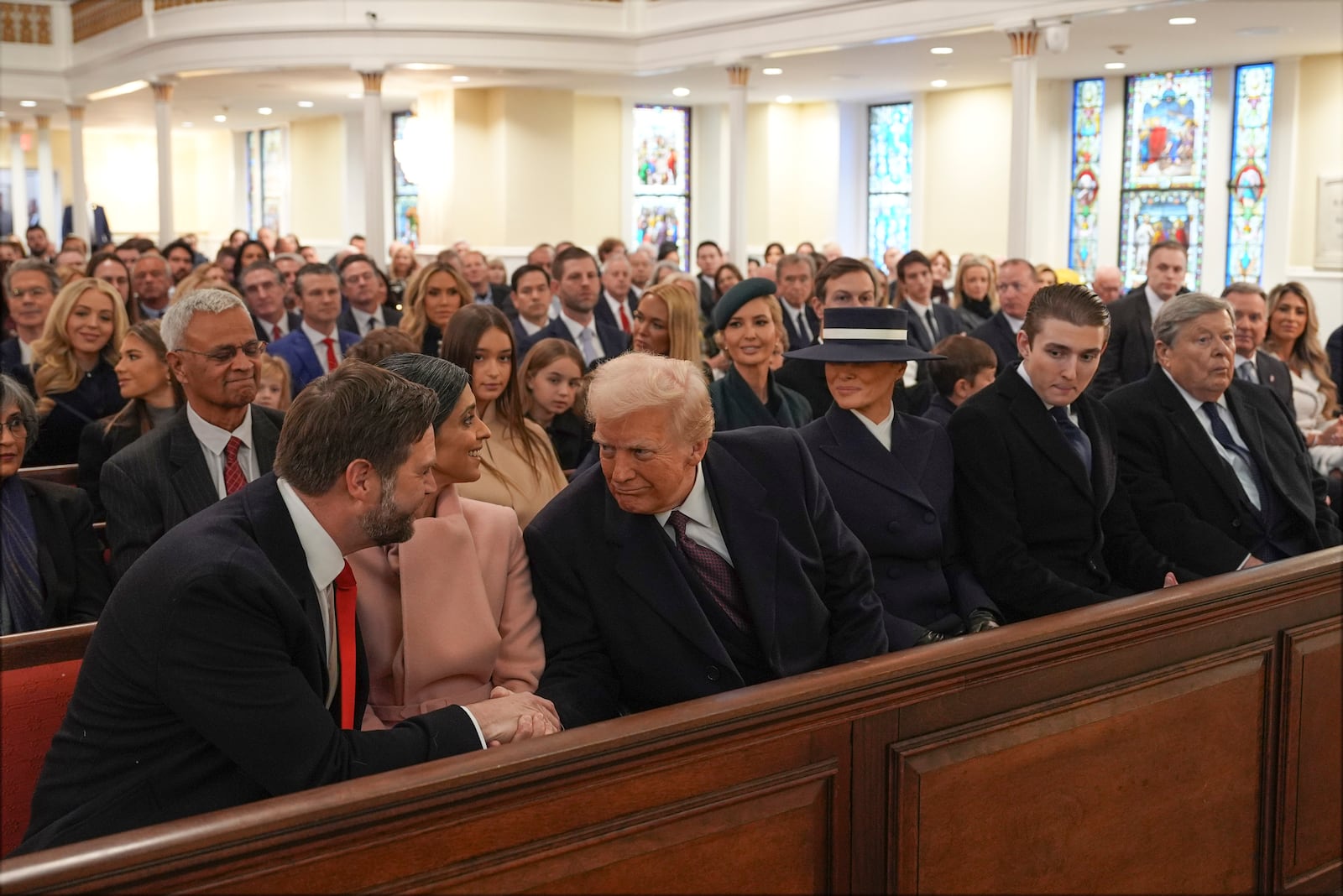 President-elect Donald Trump shakes hands with Vice President-elect JD Vance as Usha Vance, Melania Trump, Barron Trump and Victor Knavs watch before a service at St. John's Church, Monday, Jan. 20, 2025, in Washington, ahead of the 60th Presidential Inauguration. (AP Photo/Evan Vucci)