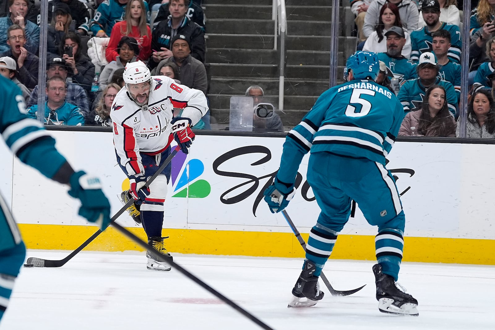 Washington Capitals left wing Alex Ovechkin (8) shoots at the goal against San Jose Sharks defenseman Vincent Desharnais (5) during the second period of an NHL hockey game in San Jose, Calif., Saturday, March 15, 2025. (AP Photo/Tony Avelar)