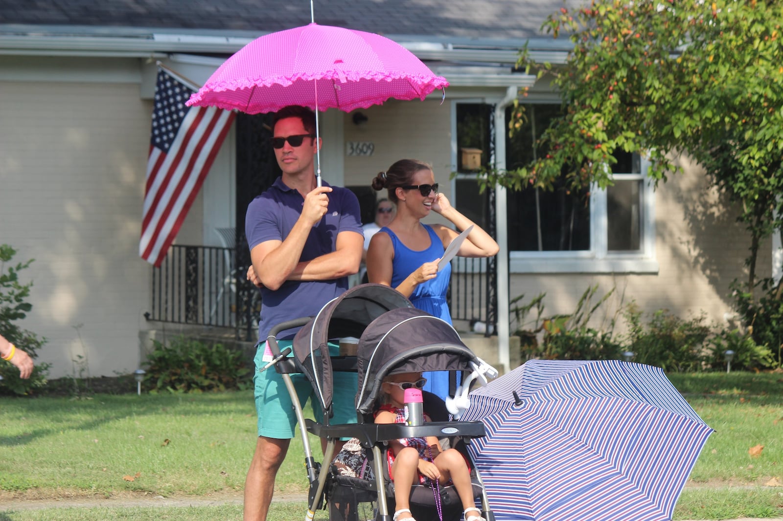 Holiday at Home spectators brought along their own shade to keep cool. STAFF PHOTO/Chuck Hamlin