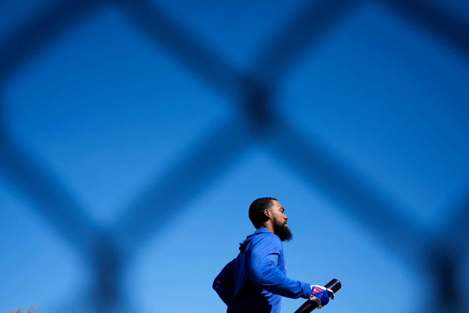 Los Angeles Dodgers outfielder Teoscar Hernández runs on the warning track during spring training baseball practice, Tuesday, Feb. 18, 2025, in Phoenix. (AP Photo/Ashley Landis)