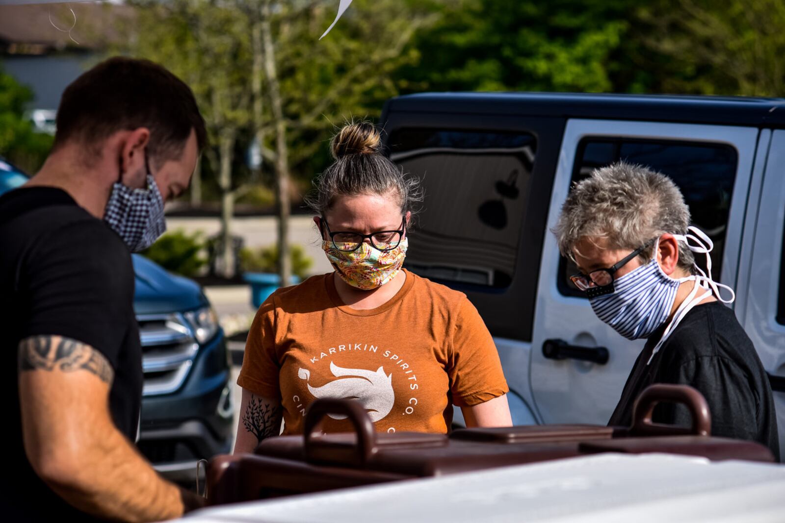 Matt Allen, left, Jamie Murzynowski, middle, and Lynnette Witsken wear masks and gloves as they prepare orders at Cozy's restaurant Tuesday, April 28, 2020 on Cincinnati Dayton Road in Liberty Township. Cozy's is trying something different on Tuesdays and Thursdays and offering a drive-up service that will vary by week. Tuesday's offering was a grill out theme with burgers, hotdogs and more available. They also had margaritas to-go for sale. Cozy's offers carry out food on other days of the week. NICK GRAHAM / STAFF