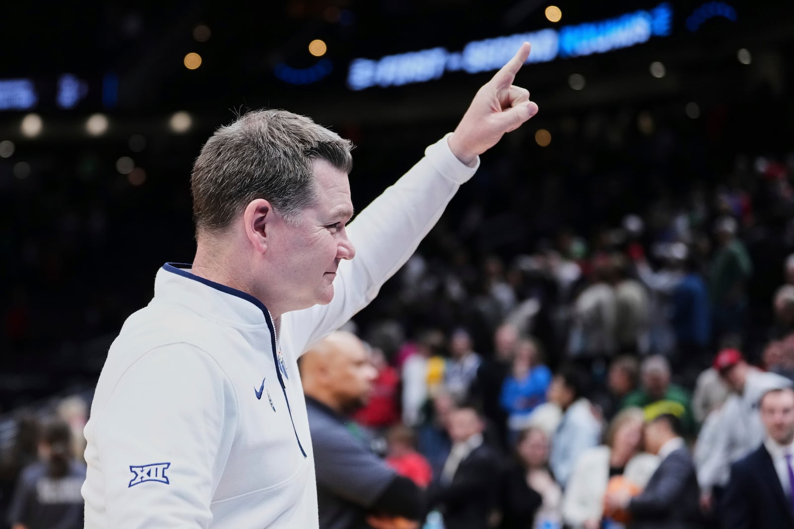 Arizona head coach Tommy Lloyd celebrates towards fans after an 87-83 win against Oregon in the second round of the NCAA college basketball tournament, Sunday, March 23, 2025 in Seattle. (AP Photo/Lindsey Wasson)