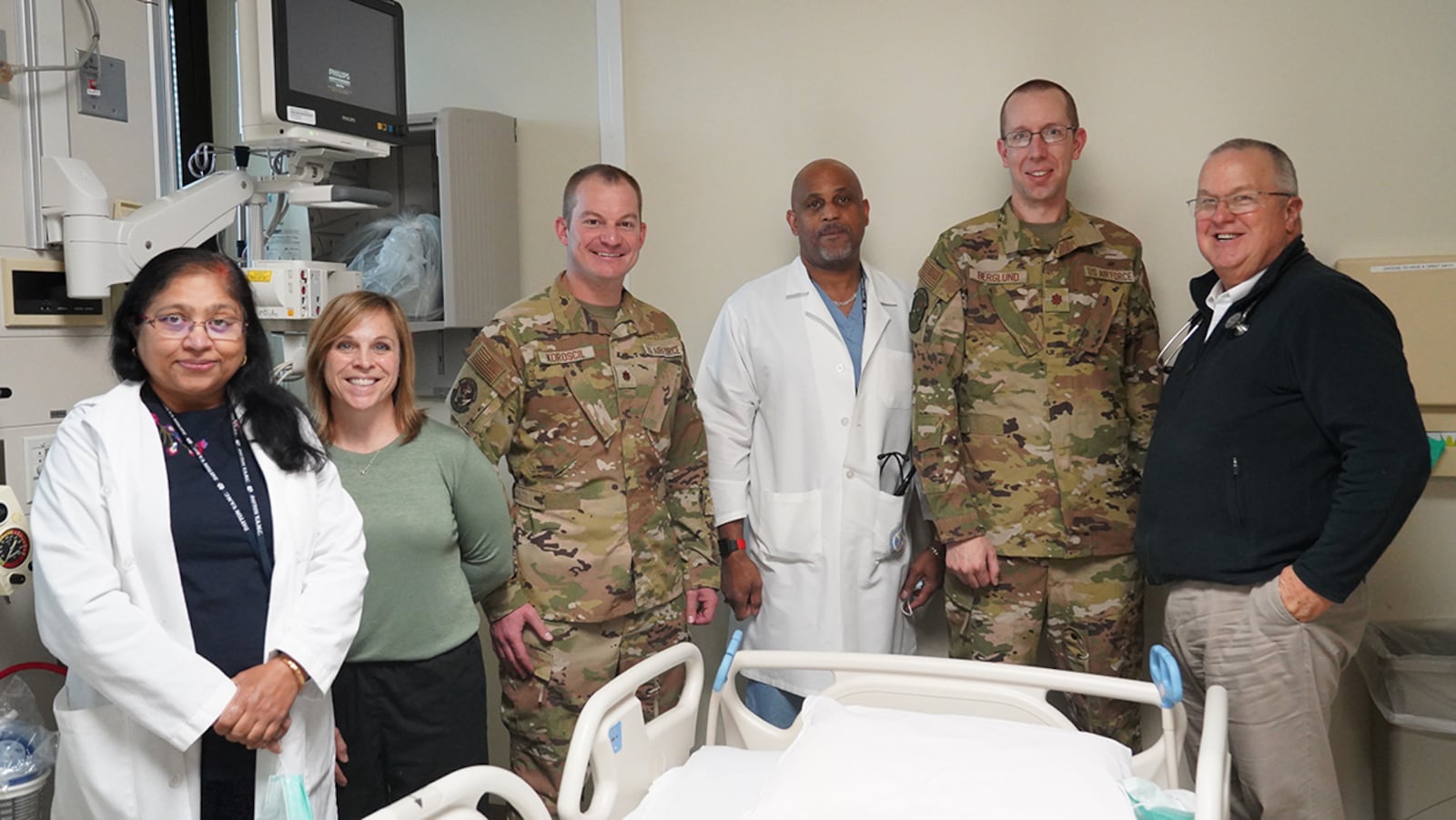 Wright-Patterson Medical Center physicians stand with the pulmonary team at Dayton VA Medical Center. Intensivists from Wright-Patterson Medical Center assist the Dayton VA Medical Center, boosting military medical training and providing the best possible critical and pulmonary care to their patients. From left: Dr. Sangeeta Srivastava, Dayton VA Medical Center, assistant chief of medicine; Dawn Russell, Dayton VA Medical Center, physician assistant; Dr. (Maj.) Matthew Koroscil, director of the Medical Intensive Care Unit, Wright-Patterson Medical Center; Byron Mitchell, Dayton VA Medical Center, physician assistant; Dr. (Maj.) Andrew Berglund, chief of Pulmonary Medicine, Wright-Patterson Medical Center; and Dr. Martin Ambrose. U.S. AIR FORCE PHOTO/KENNETH STILES