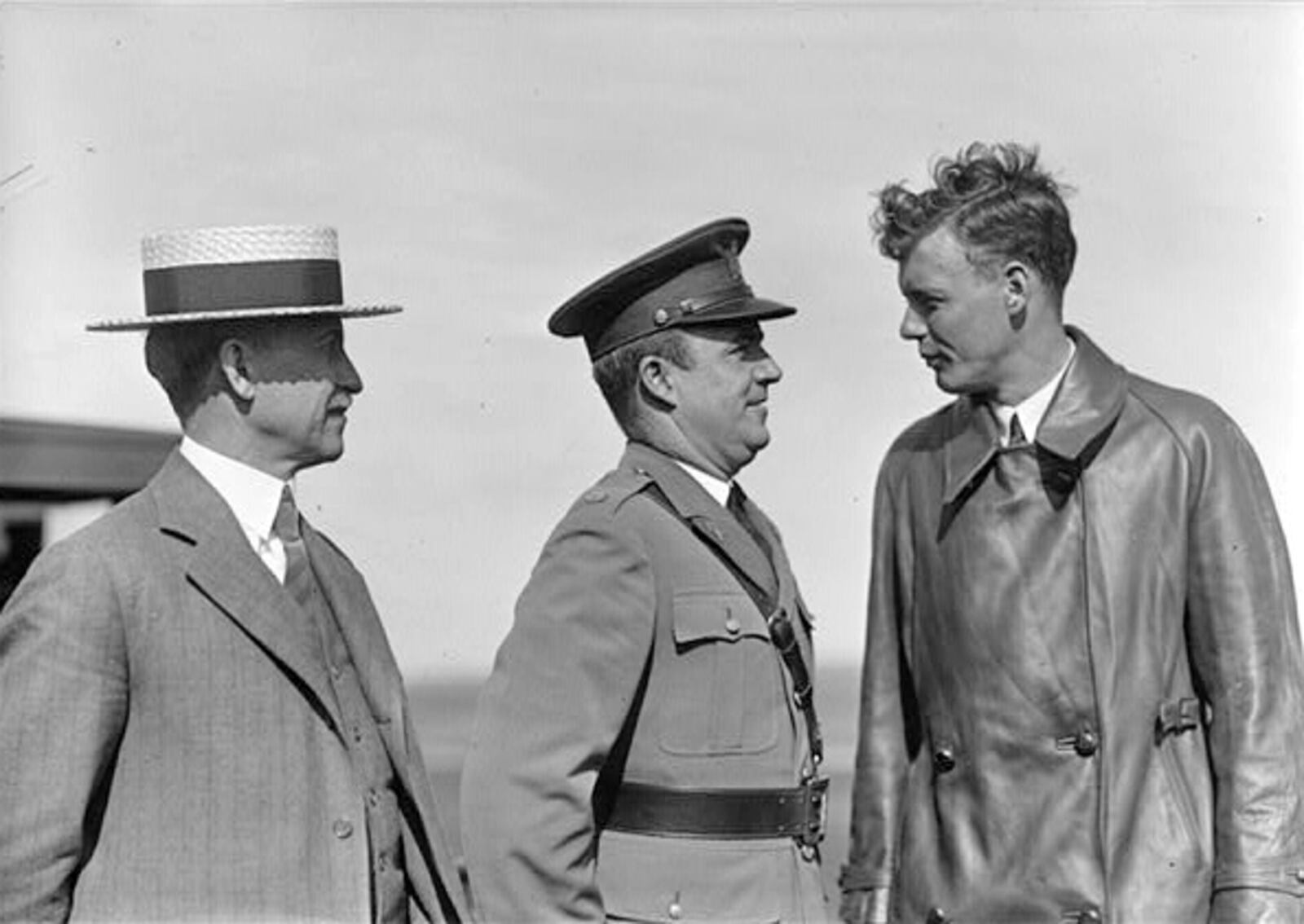 On June 22, 1927, Charles Lindbergh (right) flew into Dayton to pay his respects to Orville Wright (left). At center is Major John Curry. It was estimated that over 50,000 people lined the streets of Dayton that led from Wright Field to Orville Wright s home in Oakwood in hopes of trying to catch a glimpse of the famous flier. Lindbergh, however, refused to allow the car to take him through the crowded route and even threatened to get out and take a taxi to Orville s home unless the auto was routed through back streets to avoid the crowd. It was explained later that Lindbergh had been promised no demonstrations, yet officials had lied and set up a parade for him through the city, which was why he had acted as he had.