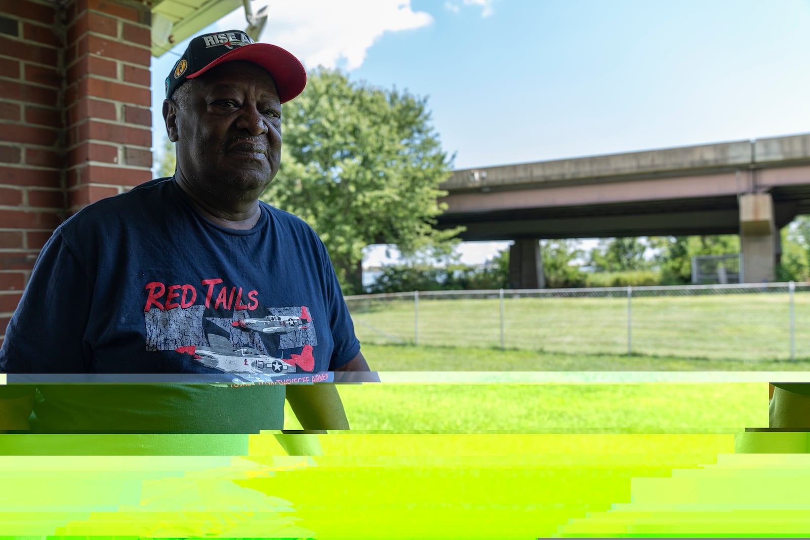 Linwood Jackson poses for a portrait at his home in Turner Station, Md., in front of the remaining portion of the Francis Scott Key Bridge, Tuesday, Aug. 13, 2024. (AP Photo/Stephanie Scarbrough)