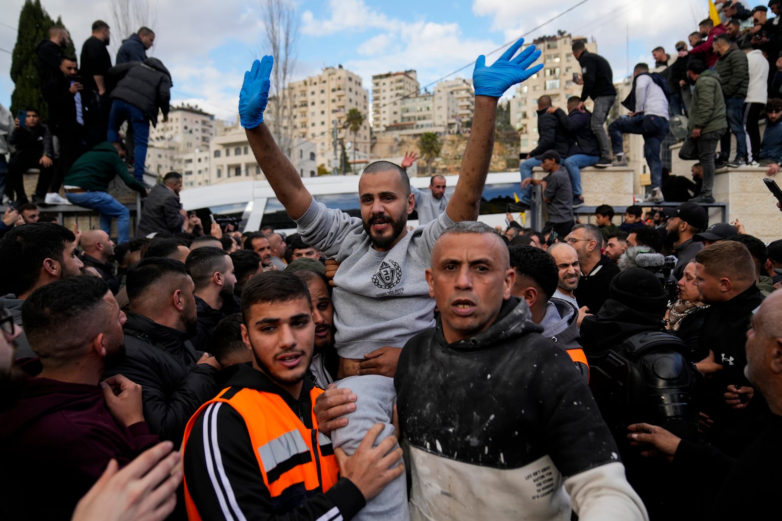 Palestinian prisoners are greeted by a crowd after being released from Israeli prison following a ceasefire agreement with Israel, in the West Bank city of Ramallah, Saturday, Jan. 25, 2025. (AP Photo/Nasser Nasser)