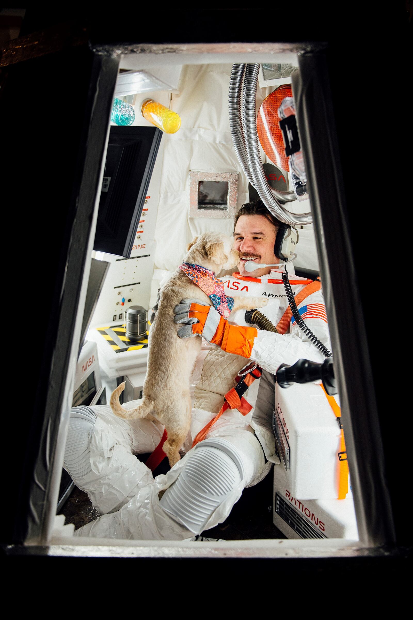 Nicholaus Arnold with dog Daisy in his installation titled "Extra-Terrestrial and Ordinary," which is from a body of multimedia astronaut-themed works. Photo by Julie Jones-Ruse
