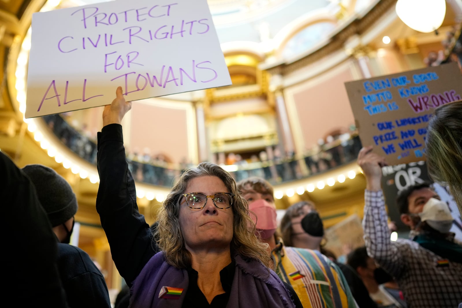 Megan Brown and other protesters fill the Iowa state Capitol to denounce a bill that would strip the state civil rights code of protections based on gender identity, Thursday, Feb. 27, 2025, in Des Moines, Iowa. (AP Photo/Charlie Neibergall)