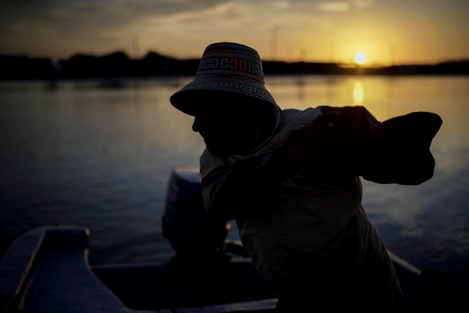 Fisher Aaron Laguna Ipuana tries to turn the boat in Cabo de la Vela, Colombia, Friday, Feb. 7, 2025. (AP Photo/Ivan Valencia)