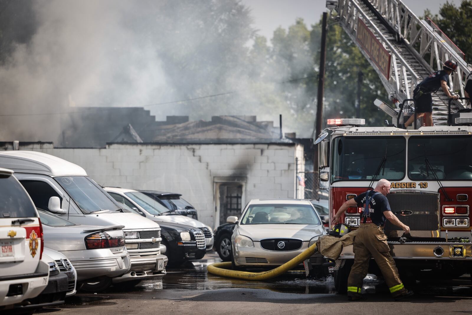 Multiple vehicles were destroyed that were inside a building also destroyed Friday afternoon, Aug. 20, 2021, during a fire at Ken’s Automotive on Valley Street in Dayton. Hazmat crews also were called to the scene. Jim Noelker/Staff